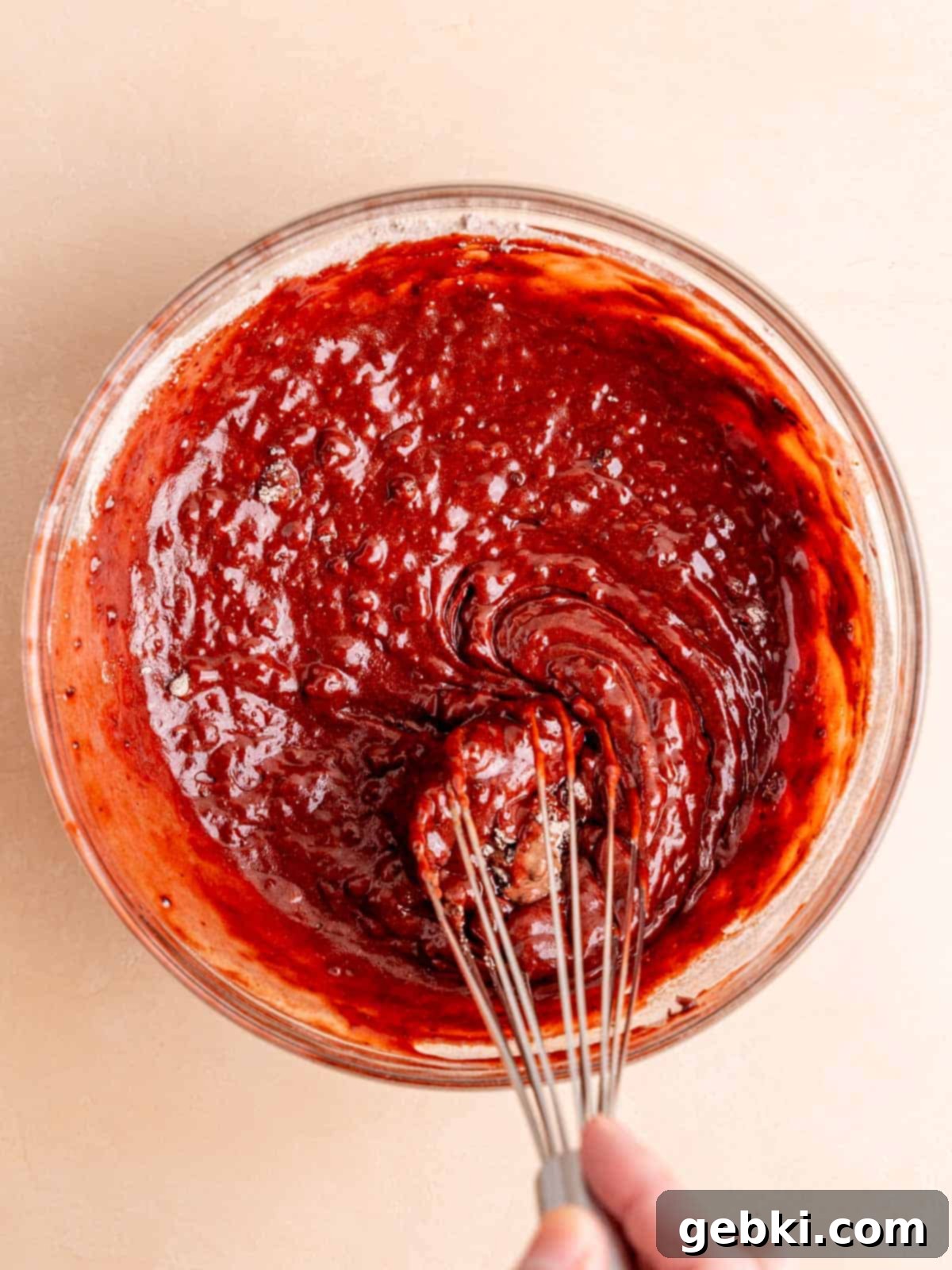 Frosted Red Velvet Donut Indulgence 6 Red velvet bake batter being whisked in a bowl.
