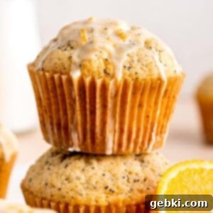 Zesty Orange Poppy Seed Muffins with Glaze 12 A stack of orange poppy seed muffins with glaze, highlighting their fluffy texture.