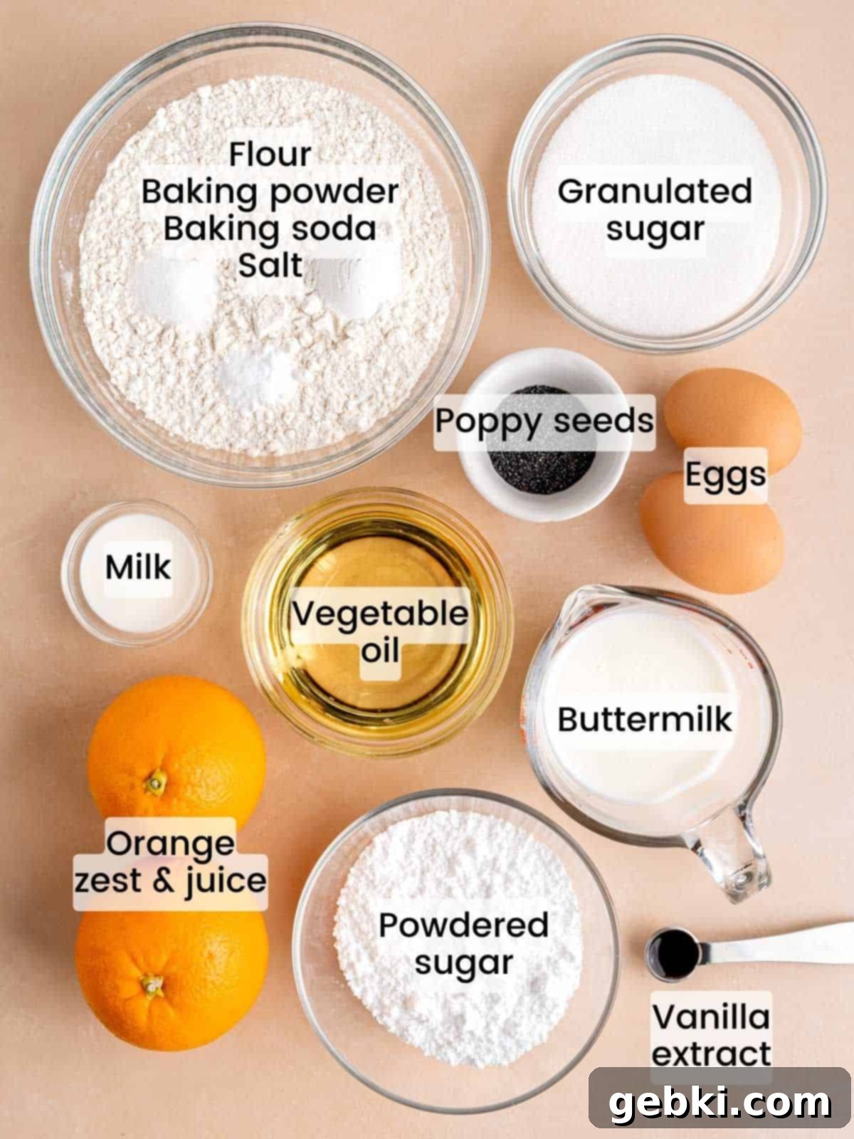 Zesty Orange Poppy Seed Muffins with Glaze 3 A selection of fresh ingredients including oranges, buttermilk, flour, and poppy seeds, ready for making muffins.