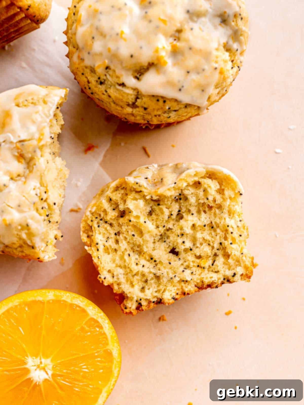 Zesty Orange Poppy Seed Muffins with Glaze 10 A perfectly baked orange poppy seed muffin cut in half, revealing its fluffy, moist interior.