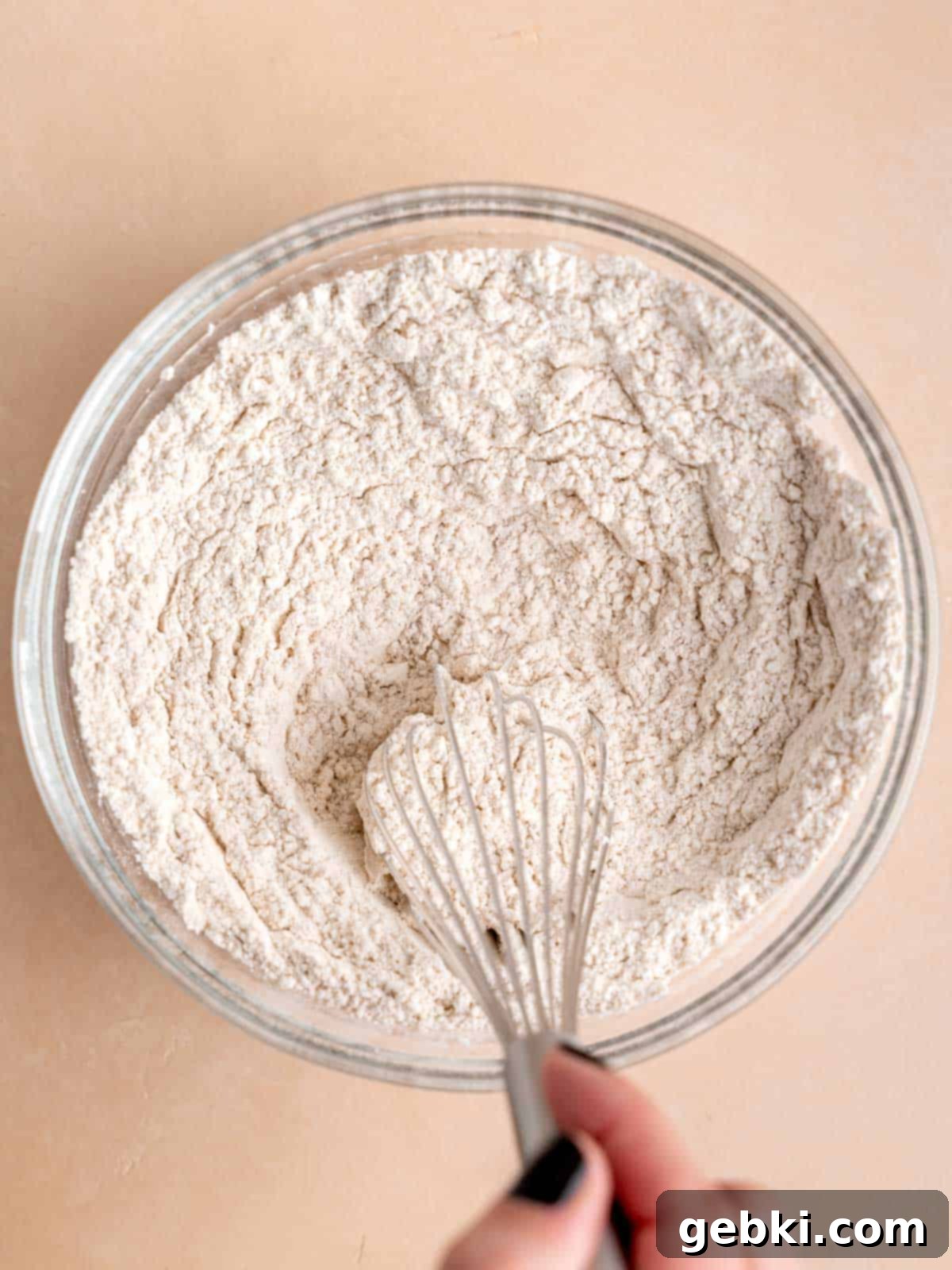 Marbleized Banana Nutella Muffins 6 Whisking together the essential dry ingredients: all-purpose flour, baking soda, salt, and ground cinnamon in a separate bowl to ensure even distribution.