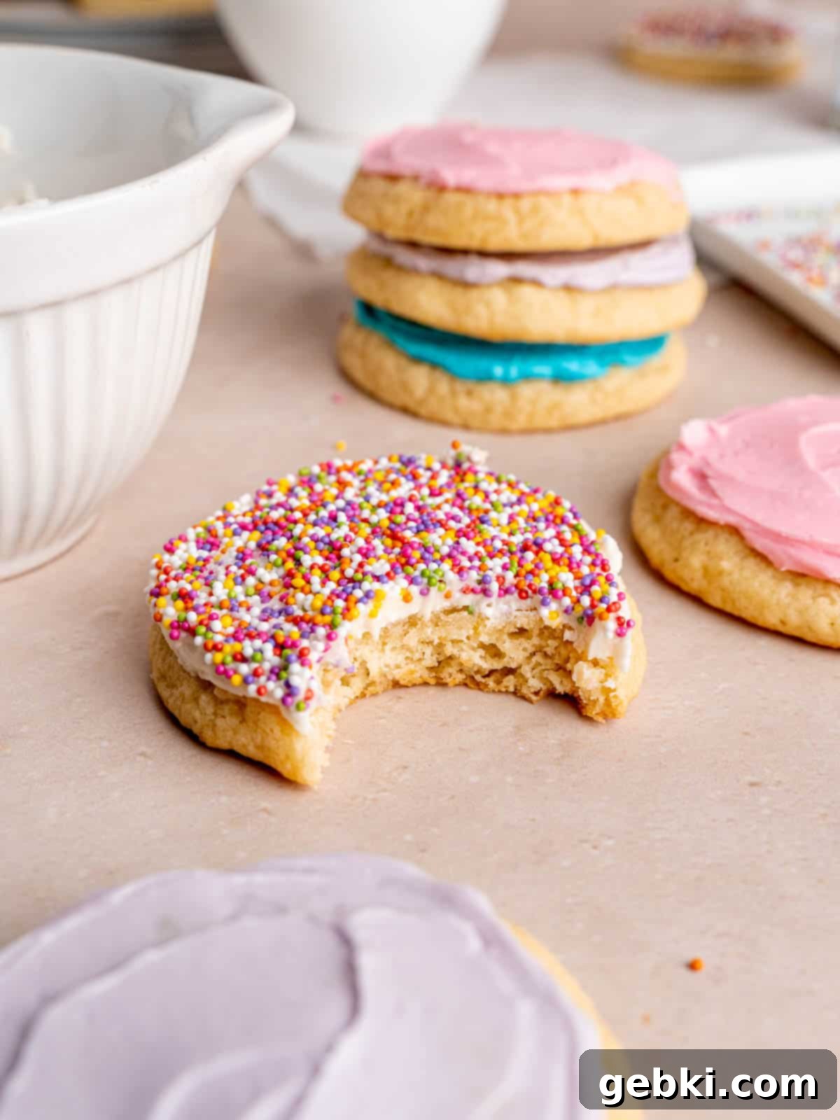 Pillowy Sour Cream Cookies with Sweet Frosting 10 A frosted sour cream cookie with a bite taken out of it.