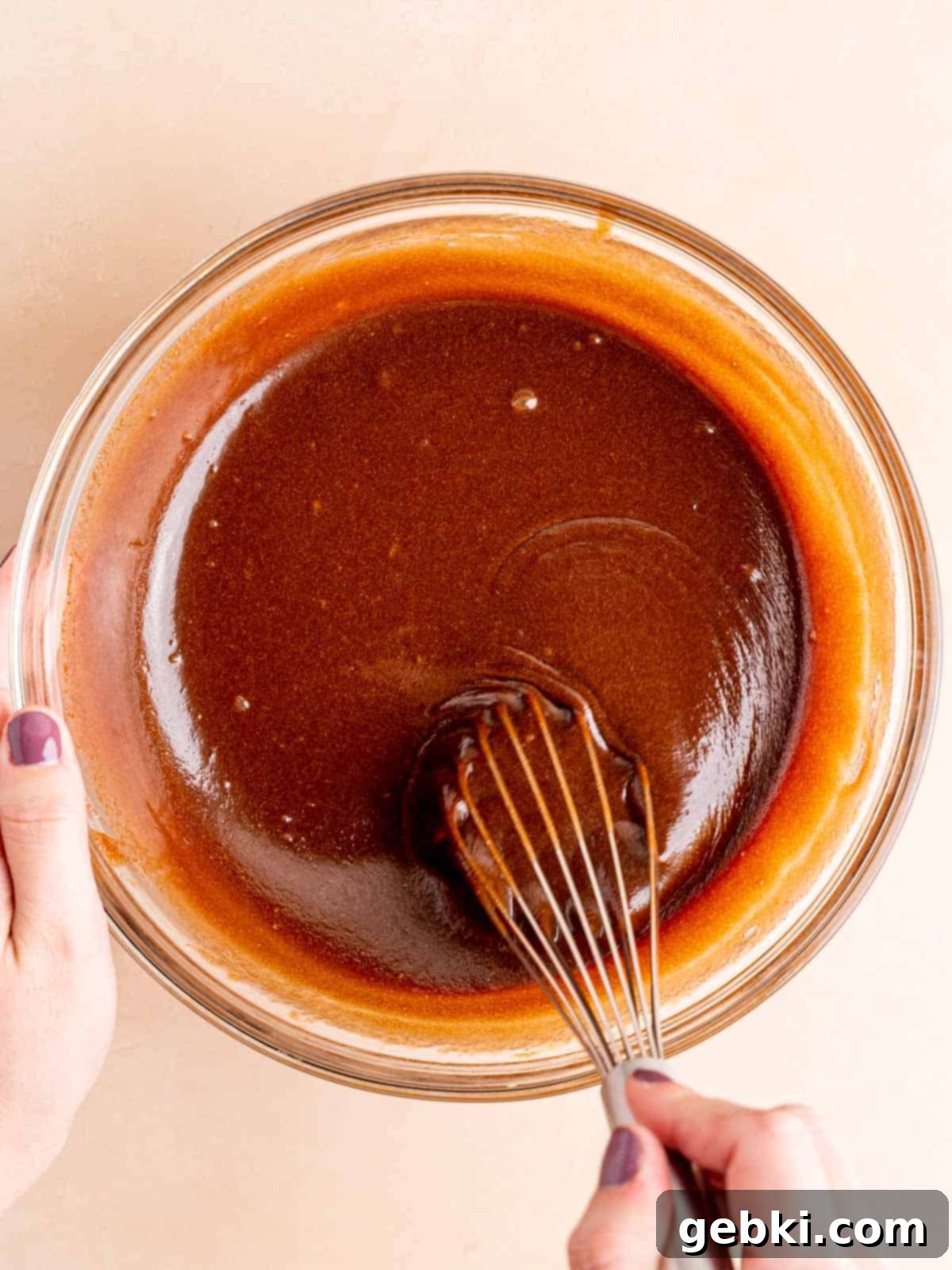 Brown sugar and eggs vigorously whisked into the melted chocolate and butter mixture.