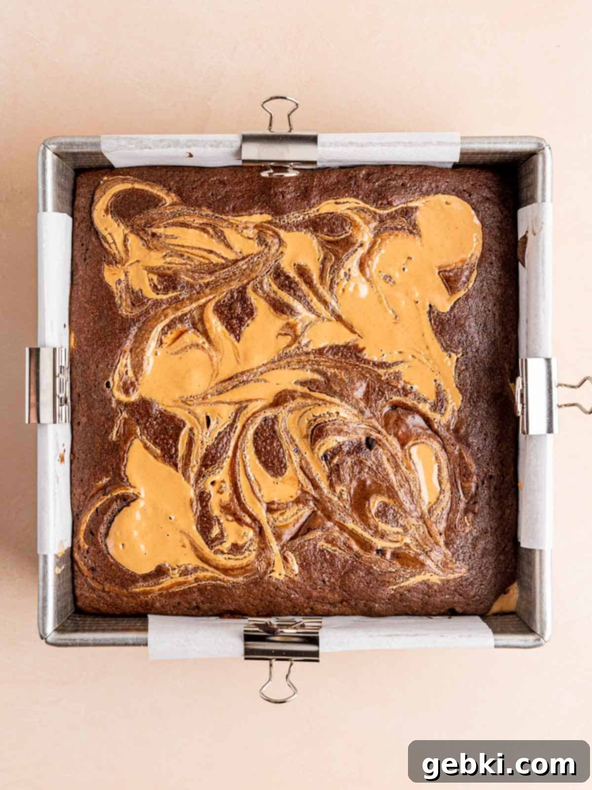 Freshly baked fudgy chocolate peanut butter brownies cooling in their pan.