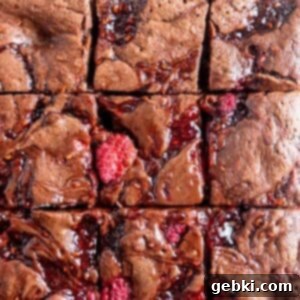 Decadent Raspberry Chocolate Fudge Brownies 12 Top view of perfectly cut chocolate raspberry brownies showcasing the fudgy interior and vibrant raspberry pieces.