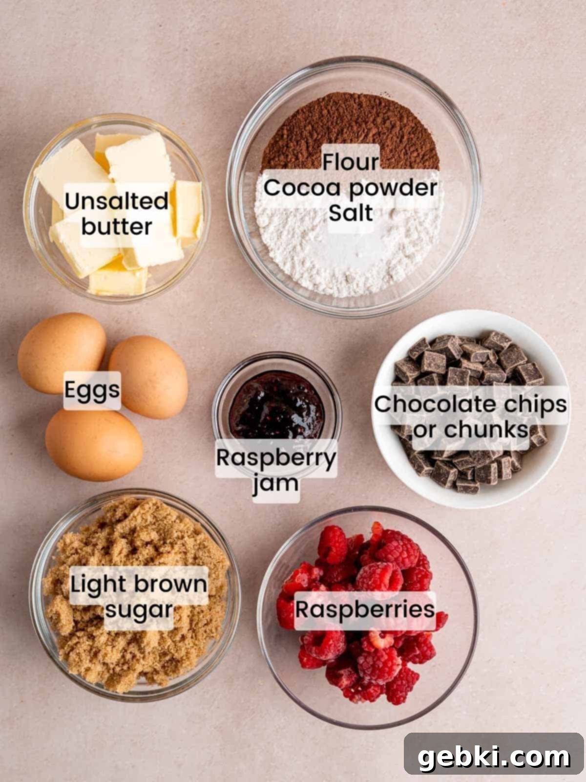 Decadent Raspberry Chocolate Fudge Brownies 3 Collection of fresh ingredients laid out, including chocolate chips, fresh raspberries, eggs, butter, flour, and brown sugar, ready for making chocolate raspberry brownies.
