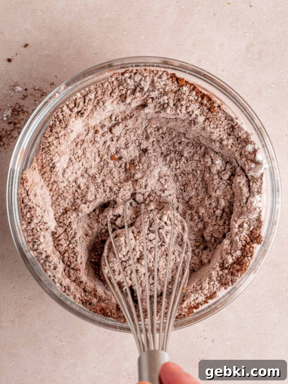 Decadent Raspberry Chocolate Fudge Brownies 7 Whisking together flour, cocoa powder, and salt in a separate medium bowl to ensure even distribution of dry ingredients.