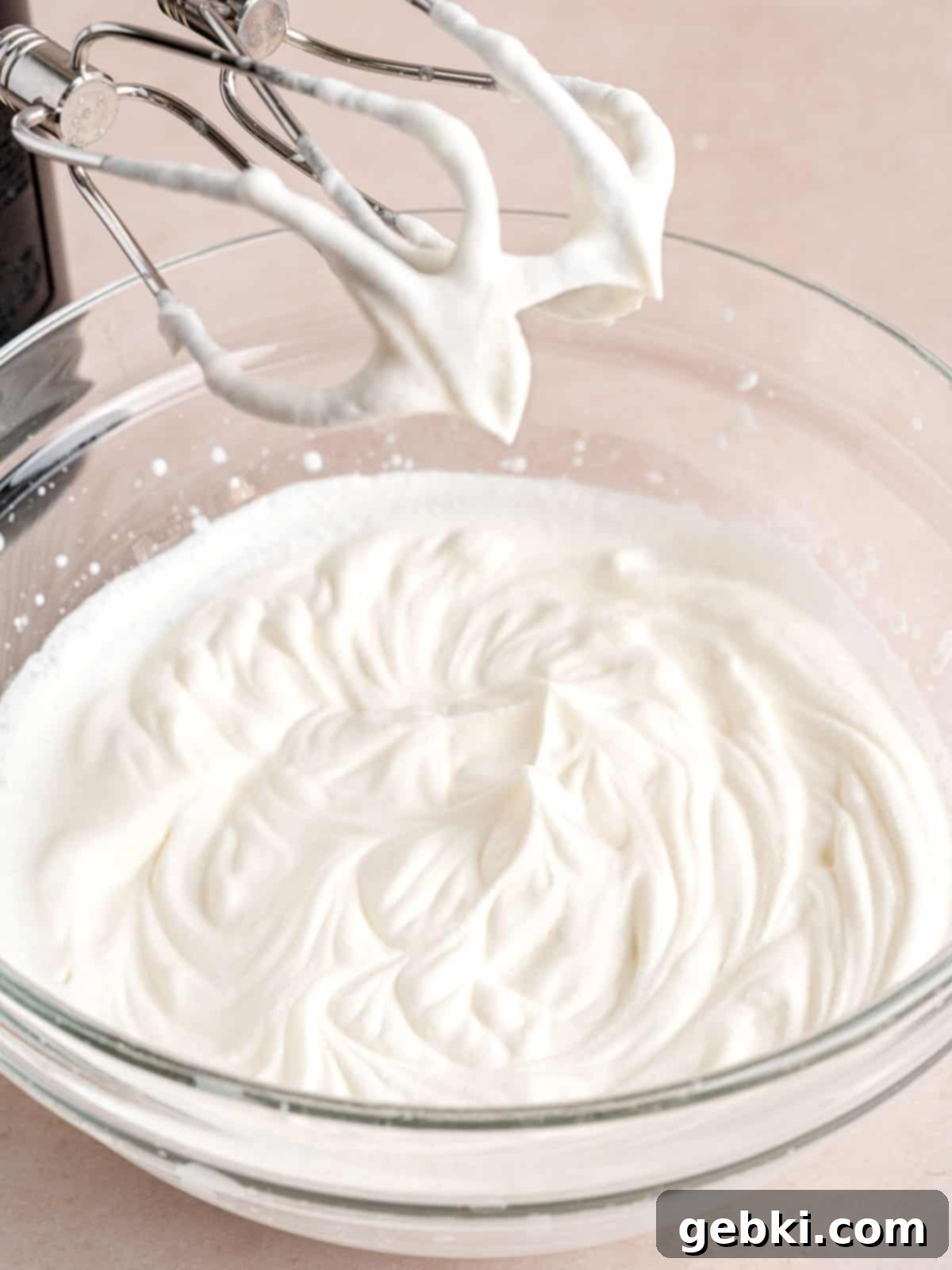 Heavy whipping cream whipped to stiff peaks using a hand mixer.