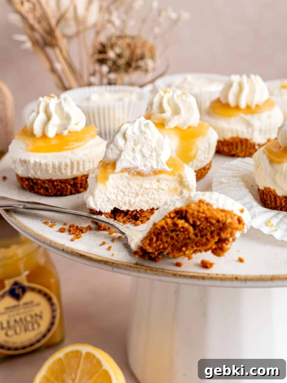 A mini no bake lemon cheesecake with a bite taken out of it.