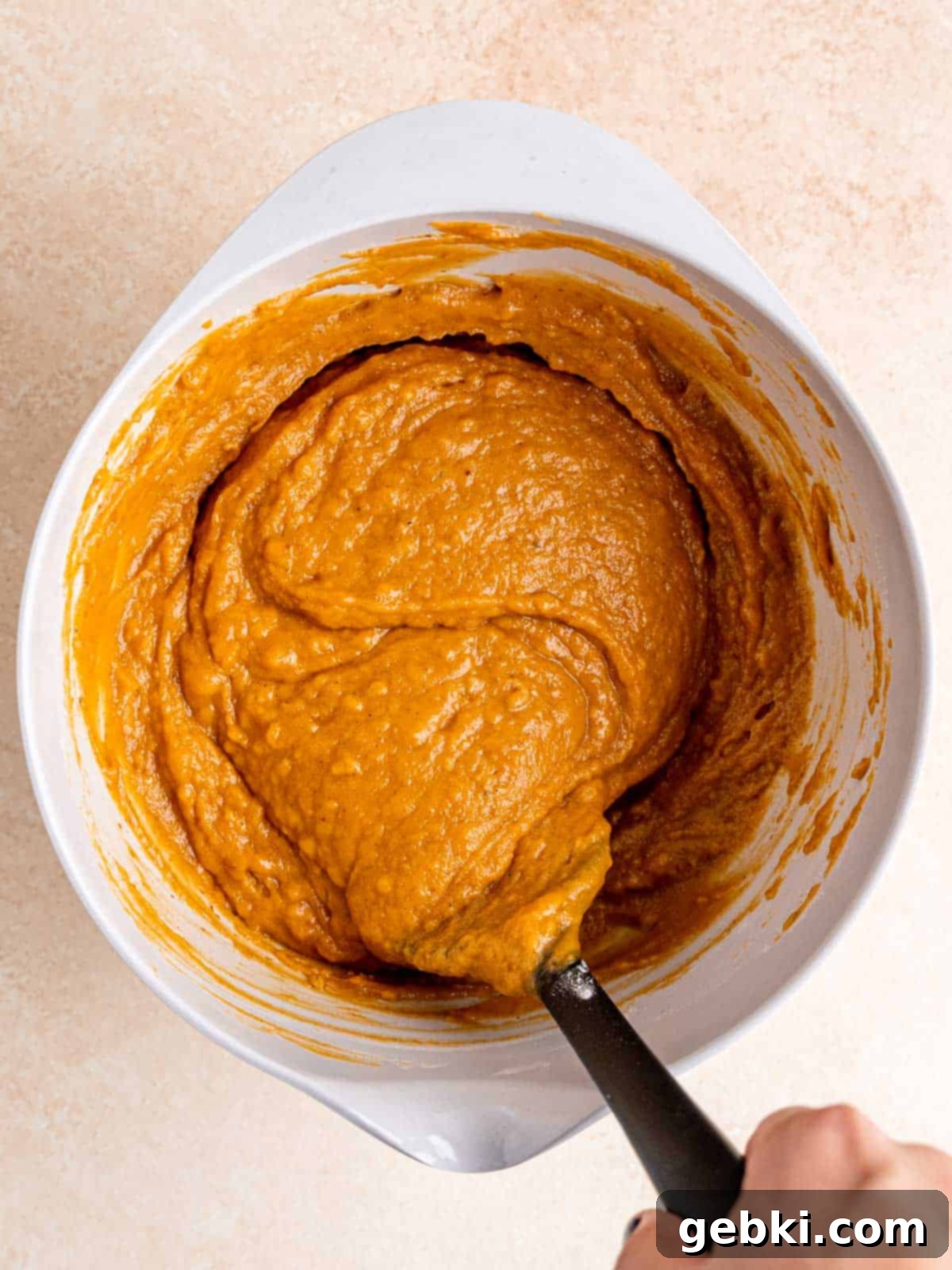 Snickerdoodle Swirl Pumpkin Bread 6 Folding dry ingredients into wet ingredients using a spatula, being careful not to overmix.