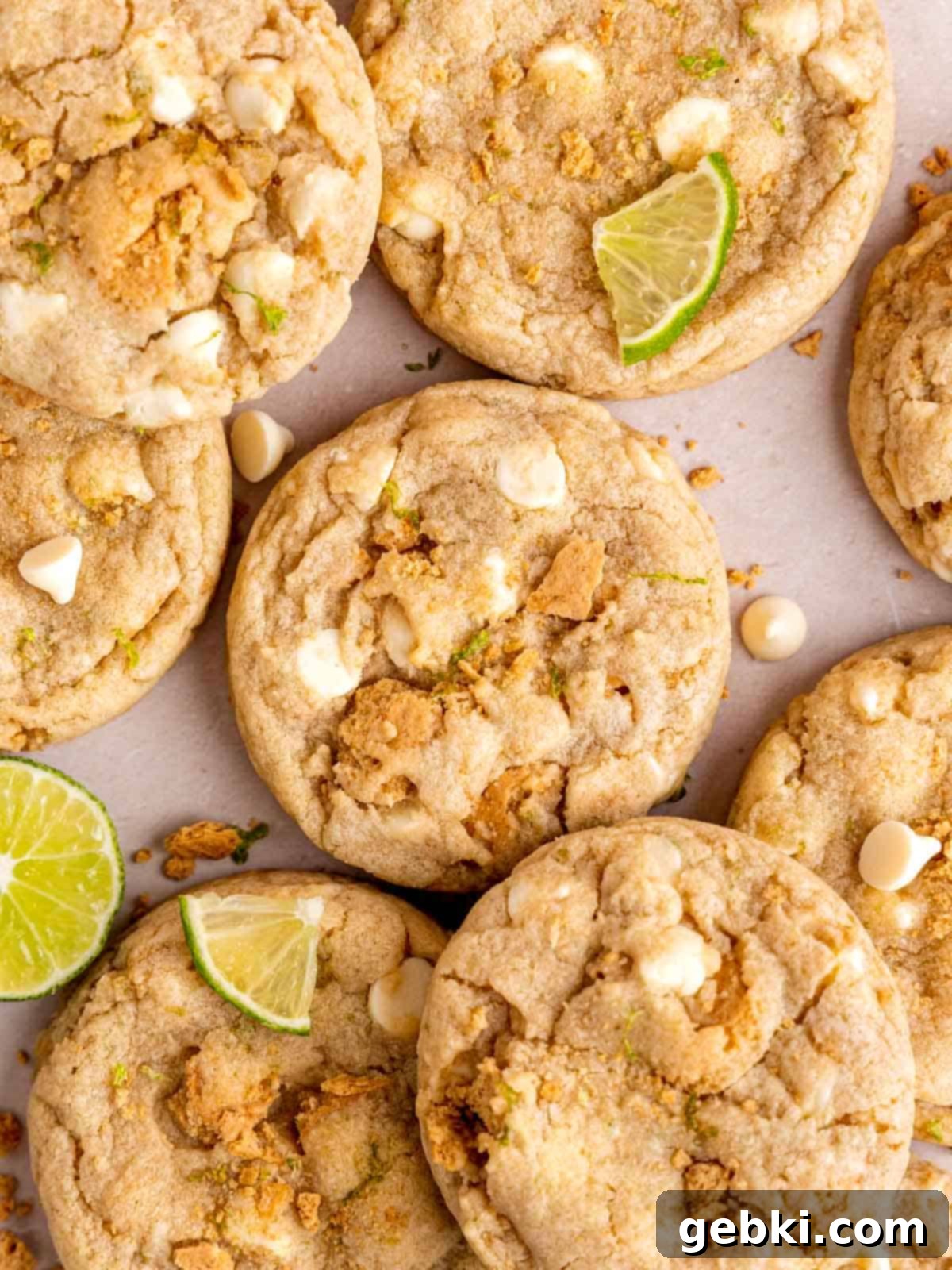 Zesty Key Lime White Chocolate Chip Cookies 8 Top-down view of beautifully baked white chocolate chip key lime cookies, some with extra white chocolate and graham cracker pieces on top.