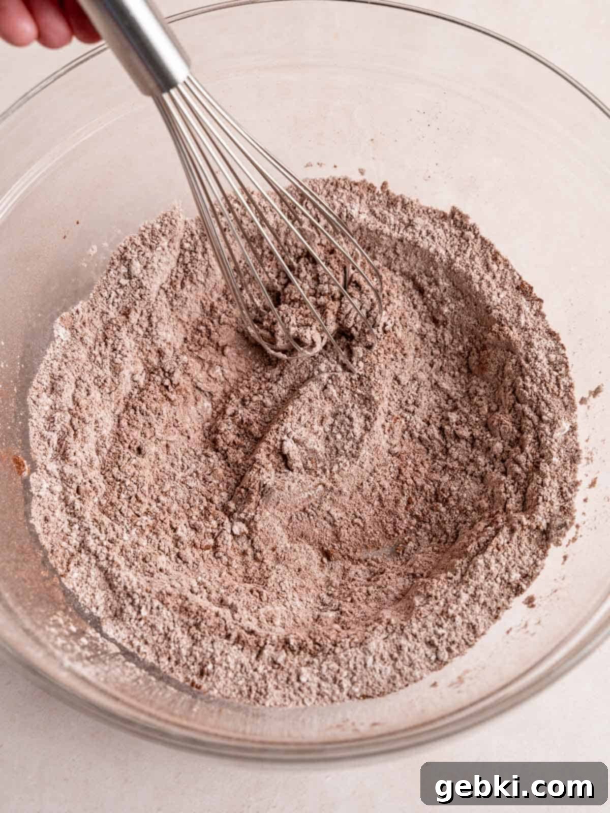 Minty Chocolate Indulgence 5 Whisking flour, cocoa powder, baking powder, baking soda, and salt in a bowl.