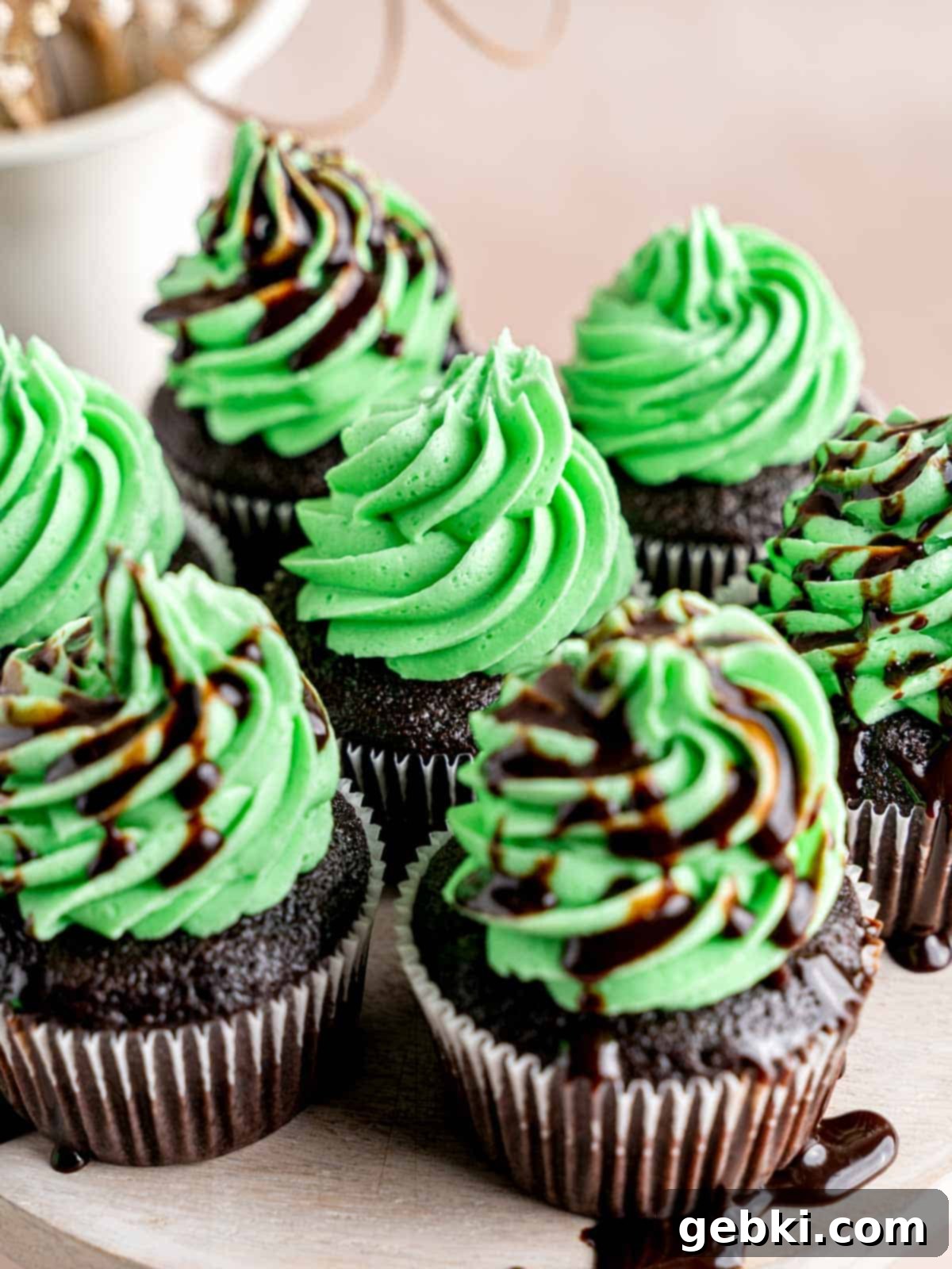 Minty Chocolate Indulgence 9 Mint chocolate cupcakes with green mint frosting piped on top, ready to serve.