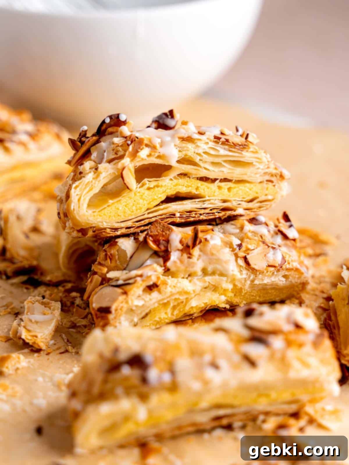 Several slices of perfectly baked almond danish pastries, drizzled with sweet icing and ready to be enjoyed.