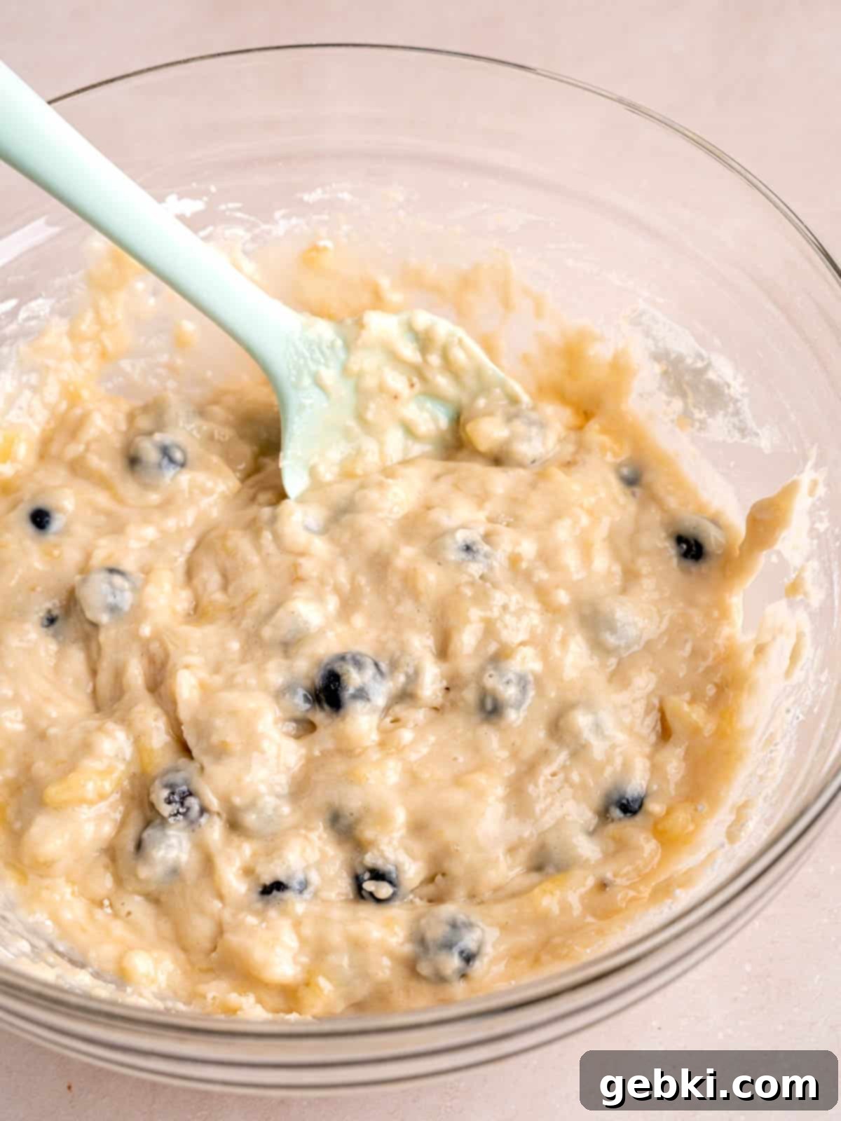 Irresistible Blueberry Banana Muffins 6 Blueberry and banana muffin batter in a bowl.