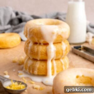 A stack of baked lemon donuts with icing.