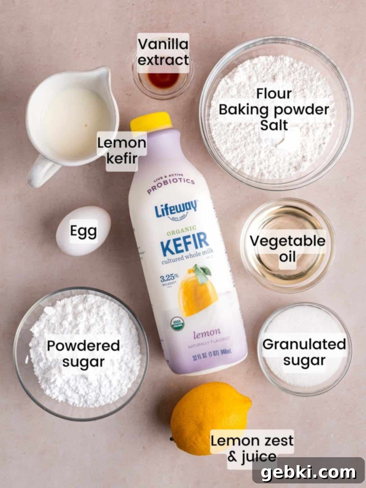 Ingredients needed to make baked lemon donuts with icing, including lemons, flour, sugar, oil, and Lifeway Kefir.