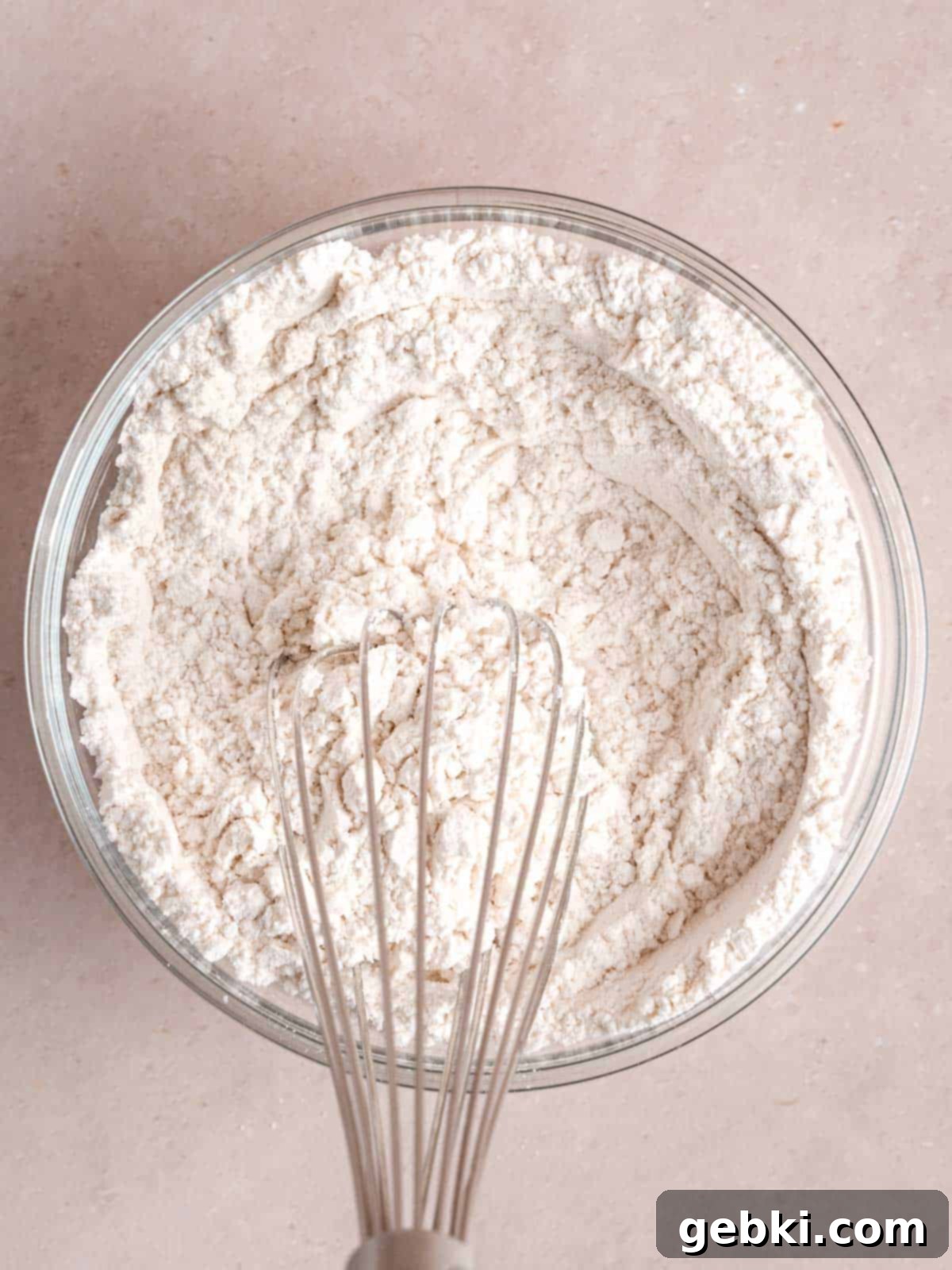 Whisking all-purpose flour, baking powder, and salt together in a medium mixing bowl.
