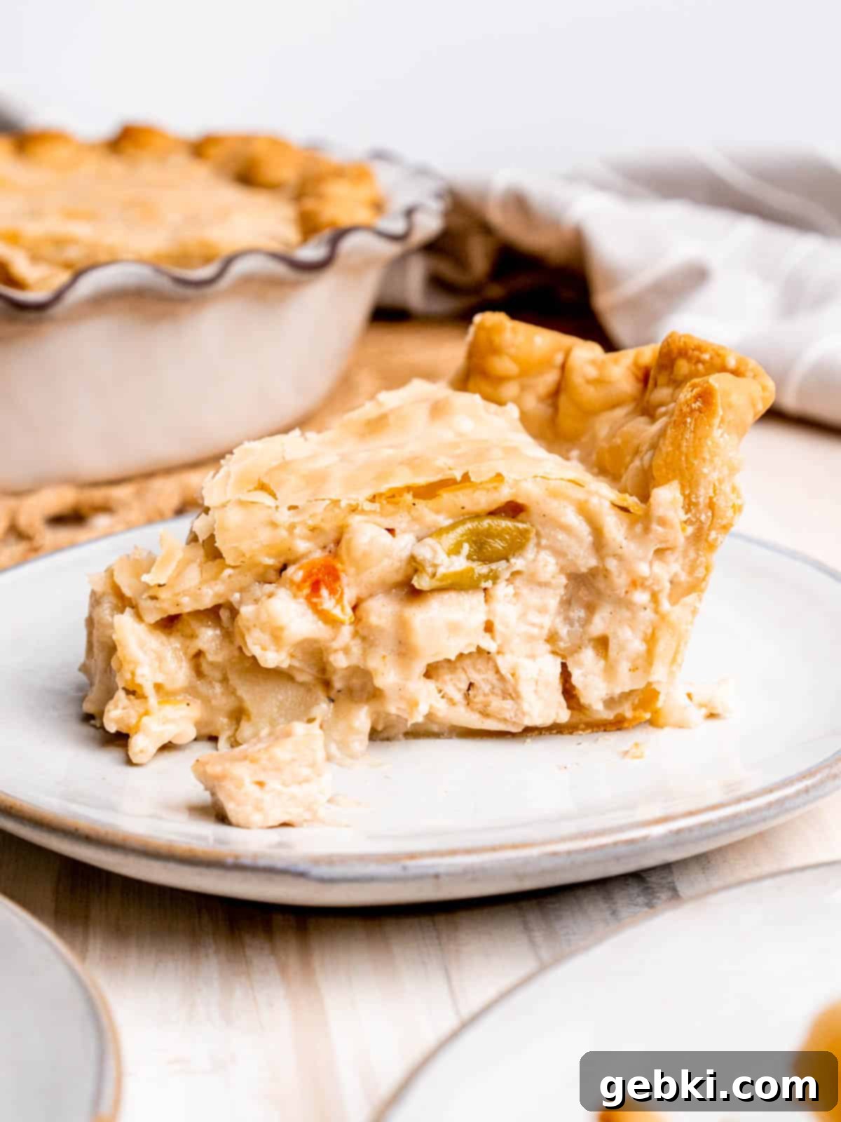 Homestyle Chicken Pot Pie 2 A slice of chicken pot pie on a plate, showing the creamy filling and golden crust