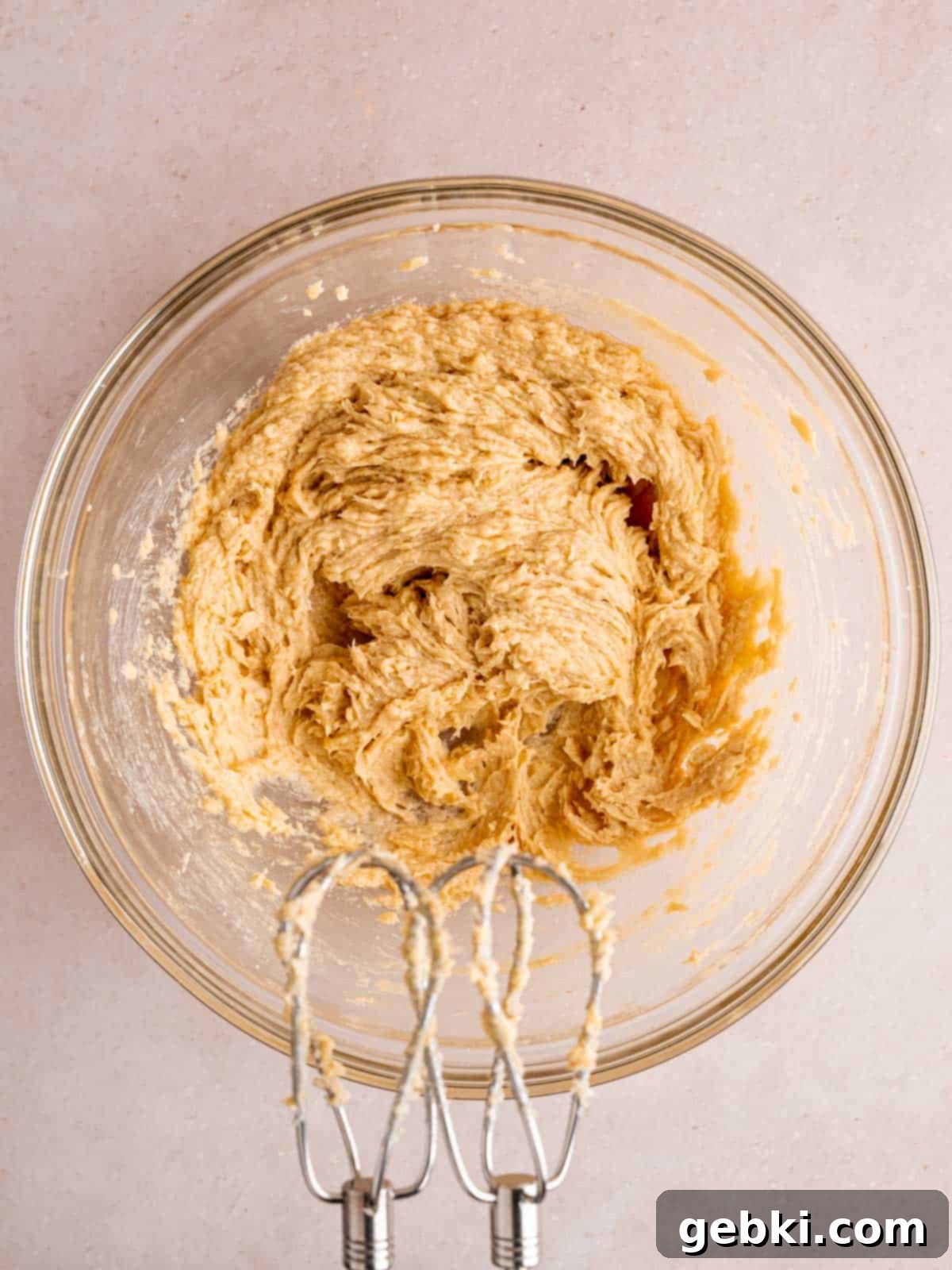 Irresistible White Chocolate Macadamia Nut Cookies 4 Butter, sugars, egg, and vanilla extract mixed together in a bowl.