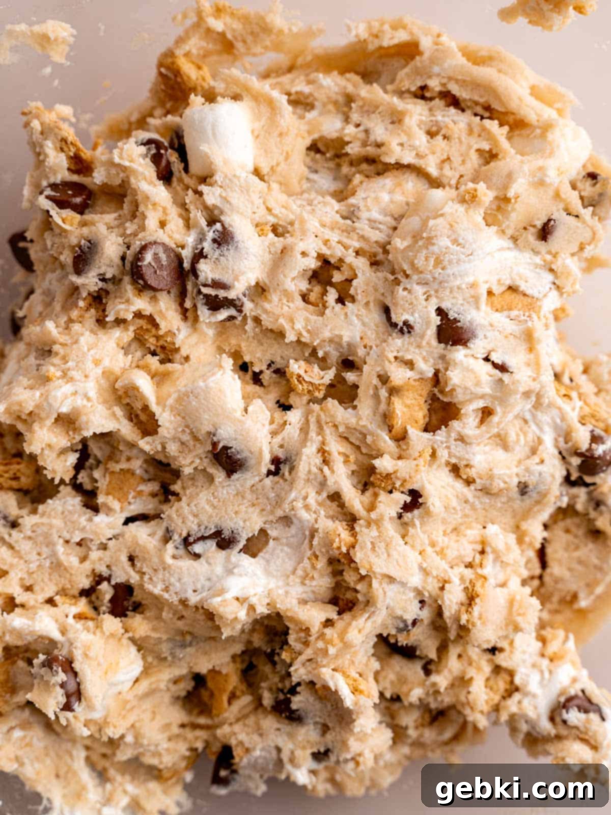 Ultimate S'mores Edible Cookie Dough 7 Finished edible s'mores cookie dough in a bowl, showing mixed-in chocolate, graham crackers, and marshmallows.