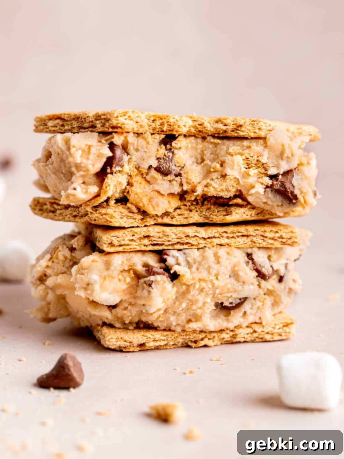Ultimate S'mores Edible Cookie Dough 8 S'mores edible cookie dough generously sandwiched between two graham crackers, ready to be eaten.