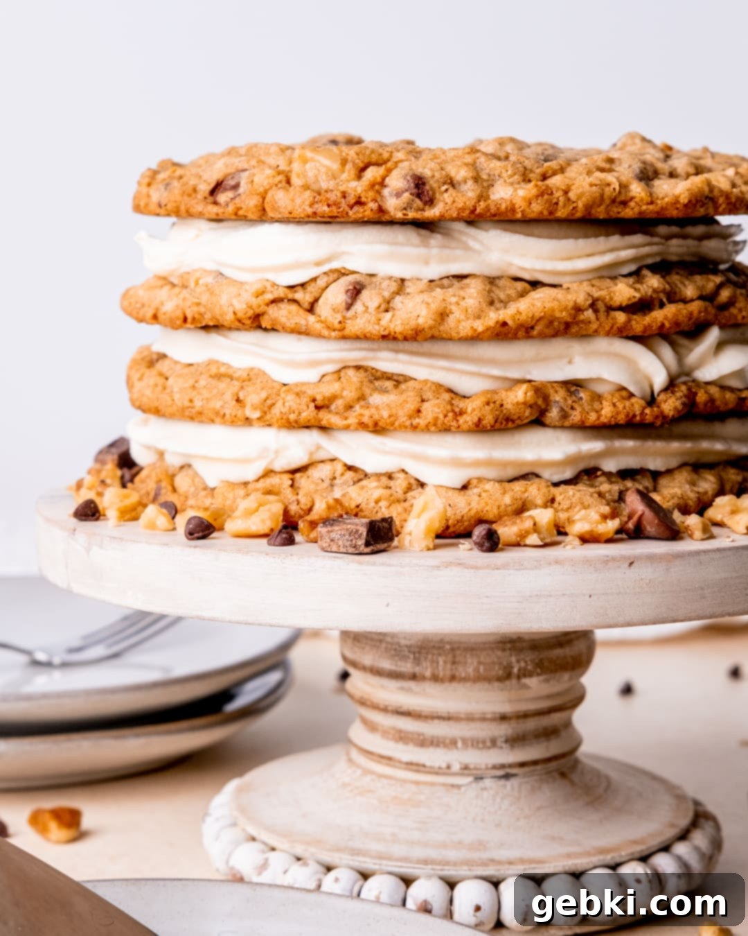 Frontier Cookie Cake 2 A stunning Cowboy Cookie Cake, artfully arranged on a cake stand, garnished with chocolate chips and chopped walnuts.