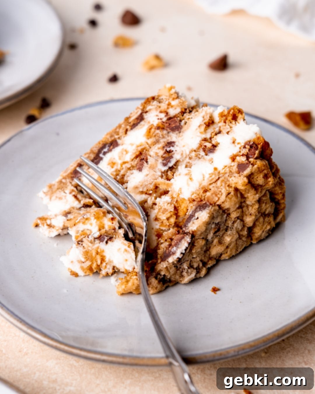 Frontier Cookie Cake 8 A fork sinking into a decadent slice of Cowboy Cookie Cake, revealing its luscious layers of cookie and cream cheese frosting.