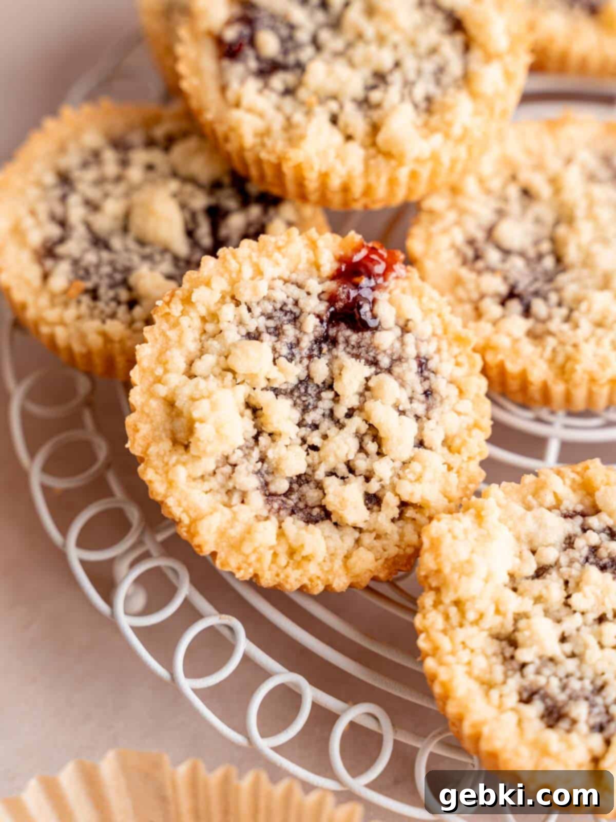 Simply Superior Easy Raspberry Crumble Cookies 10 Beautifully baked shortbread cookies with vibrant raspberry filling and golden crumbs, arranged appealingly.
