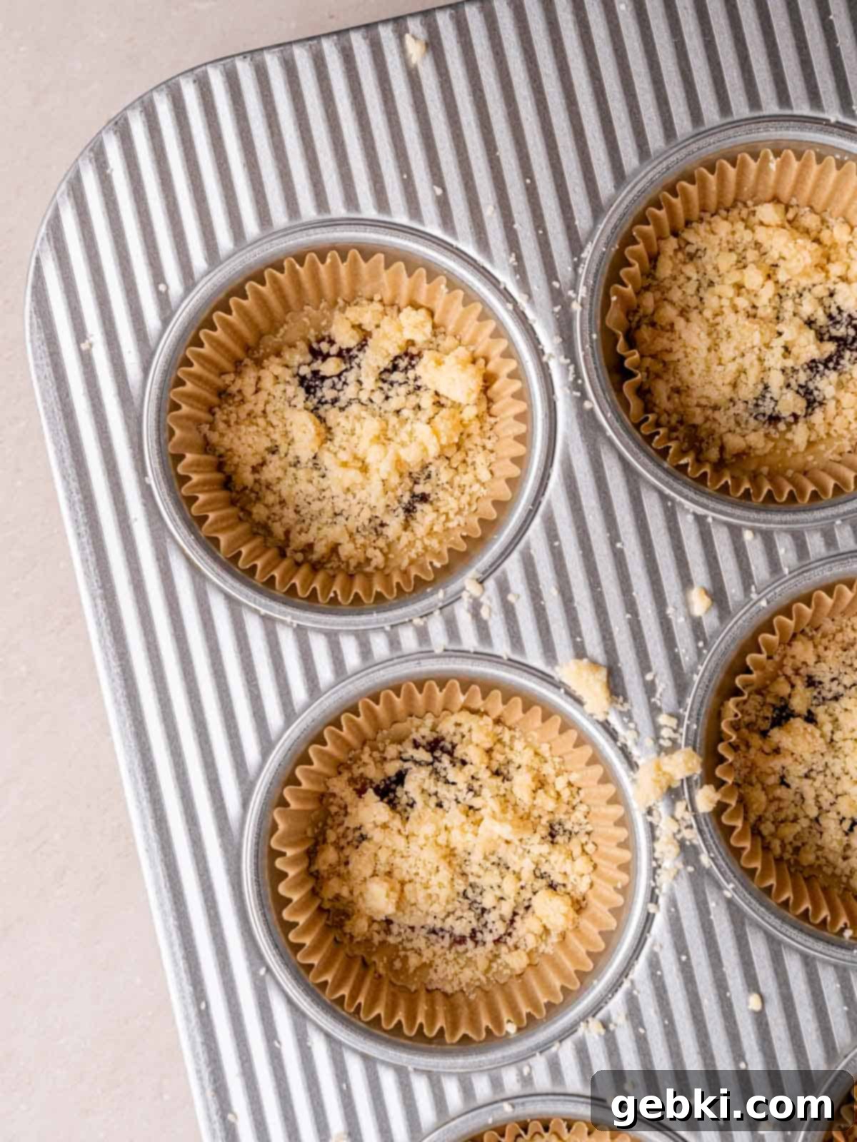 Simply Superior Easy Raspberry Crumble Cookies 8 Unbaked raspberry filled cookies in a pan, topped with crumbly dough.