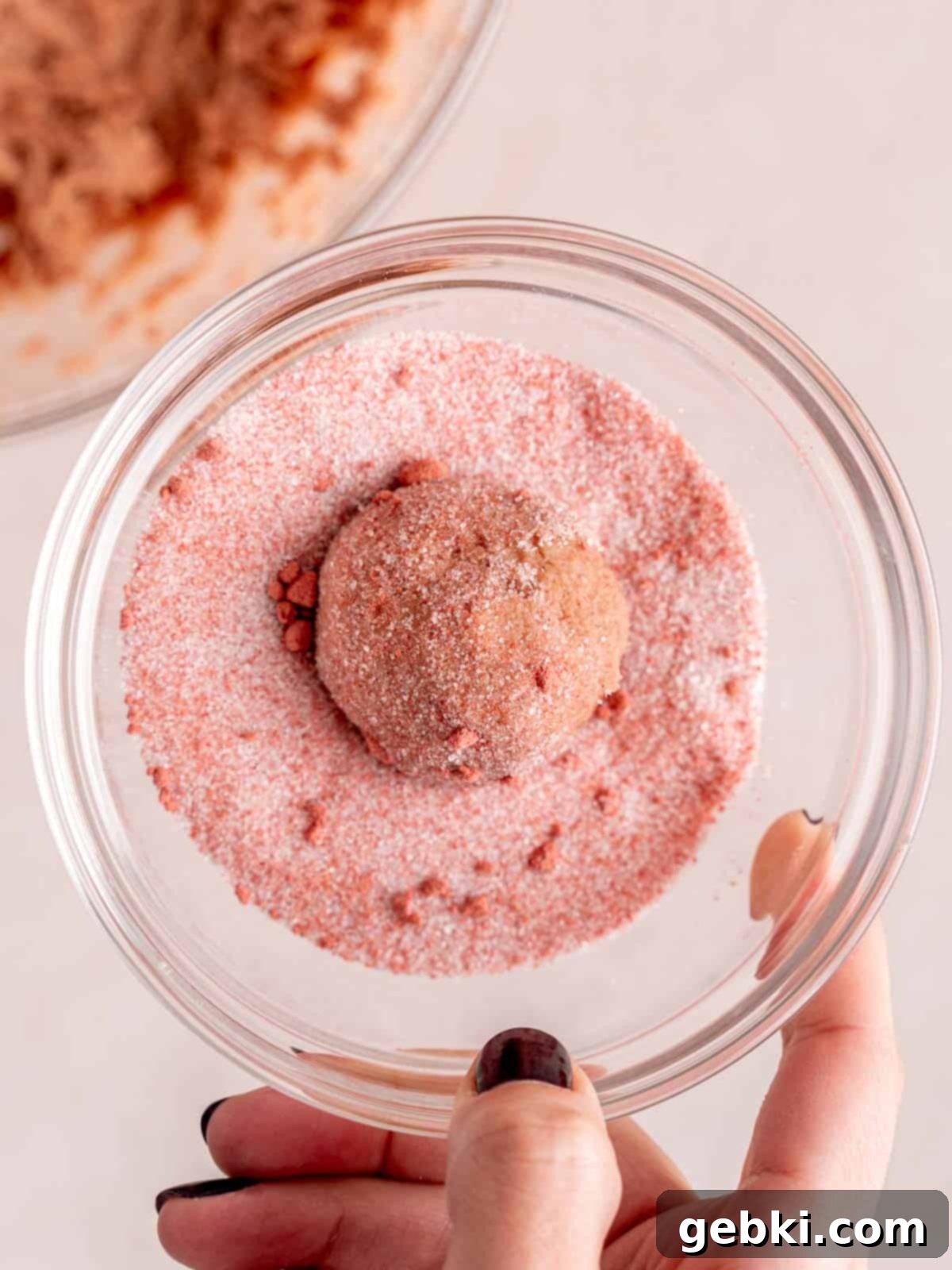 Effortlessly Soft Strawberry Sugar Cookies 6 Strawberry cookie dough balls in a mixture of sugar and freeze-dried strawberry powder.