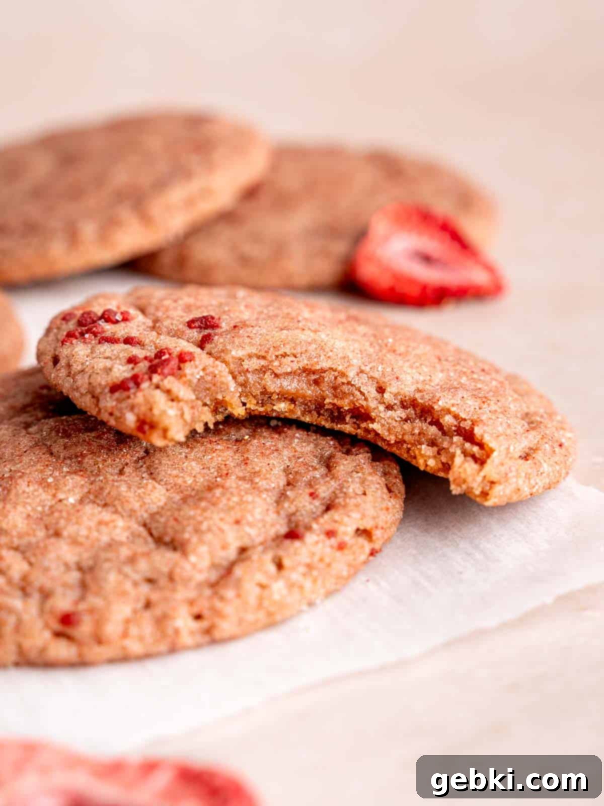 Effortlessly Soft Strawberry Sugar Cookies 8 A soft and chewy strawberry cookie with a bite taken out of it.