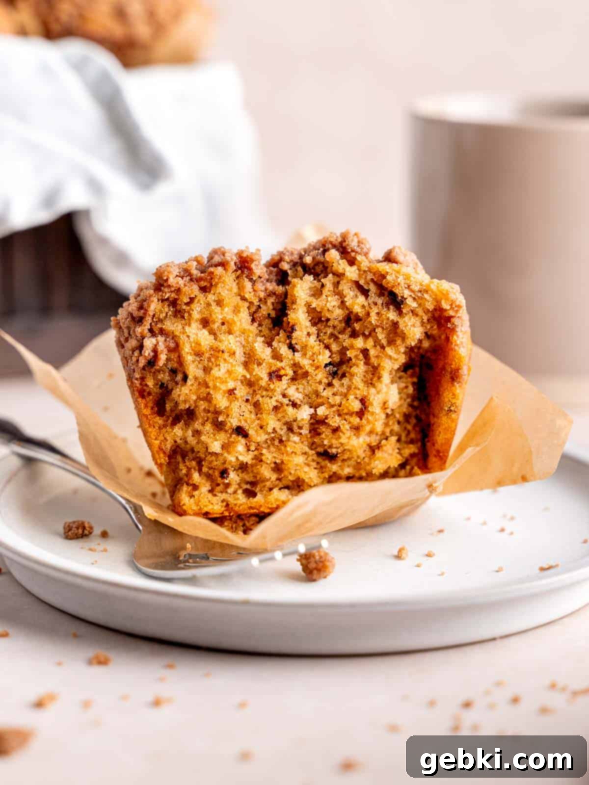Espresso Muffins with Chocolate Streusel 2 A coffee-flavored cappuccino muffin with cocoa powder streusel topping cut in half, revealing its moist interior.