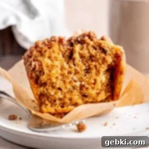 Espresso Muffins with Chocolate Streusel 12 A coffee-flavored cappuccino muffin with cocoa powder streusel topping cut in half, showcasing its moist texture.