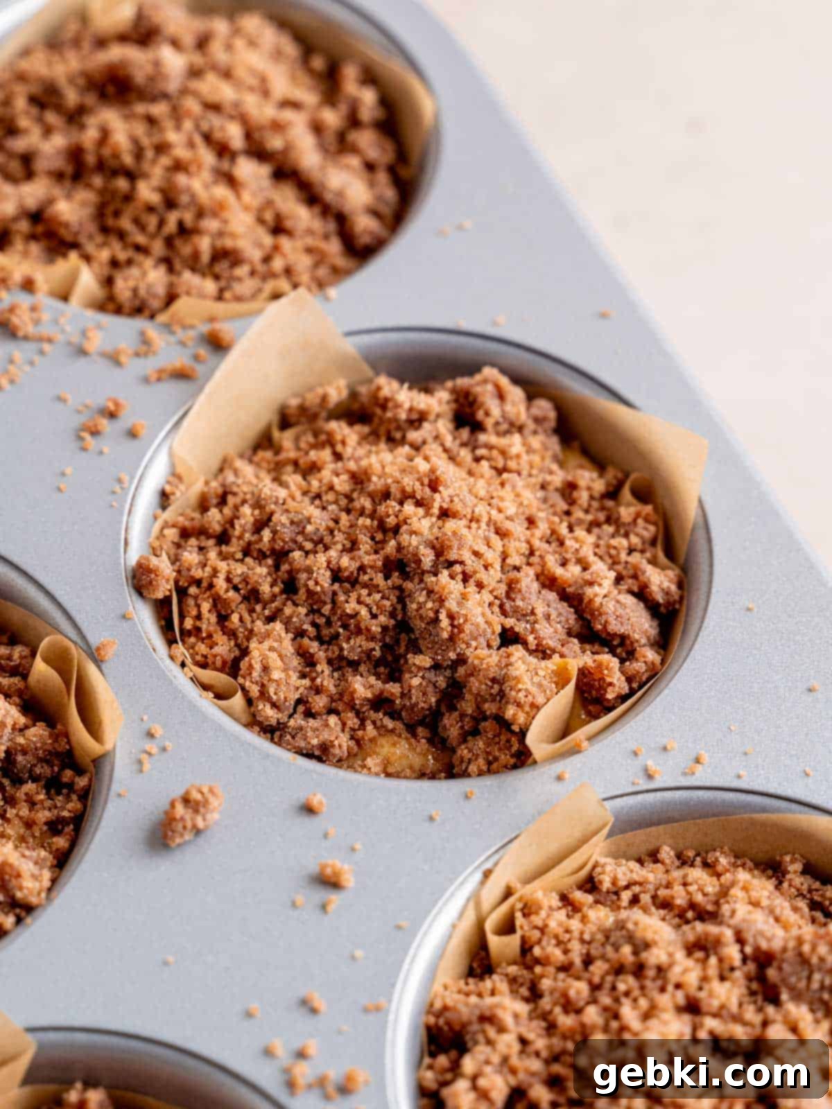 Espresso Muffins with Chocolate Streusel 9 Cappuccino muffin batter topped generously with cocoa streusel in a jumbo pan, ready for baking.