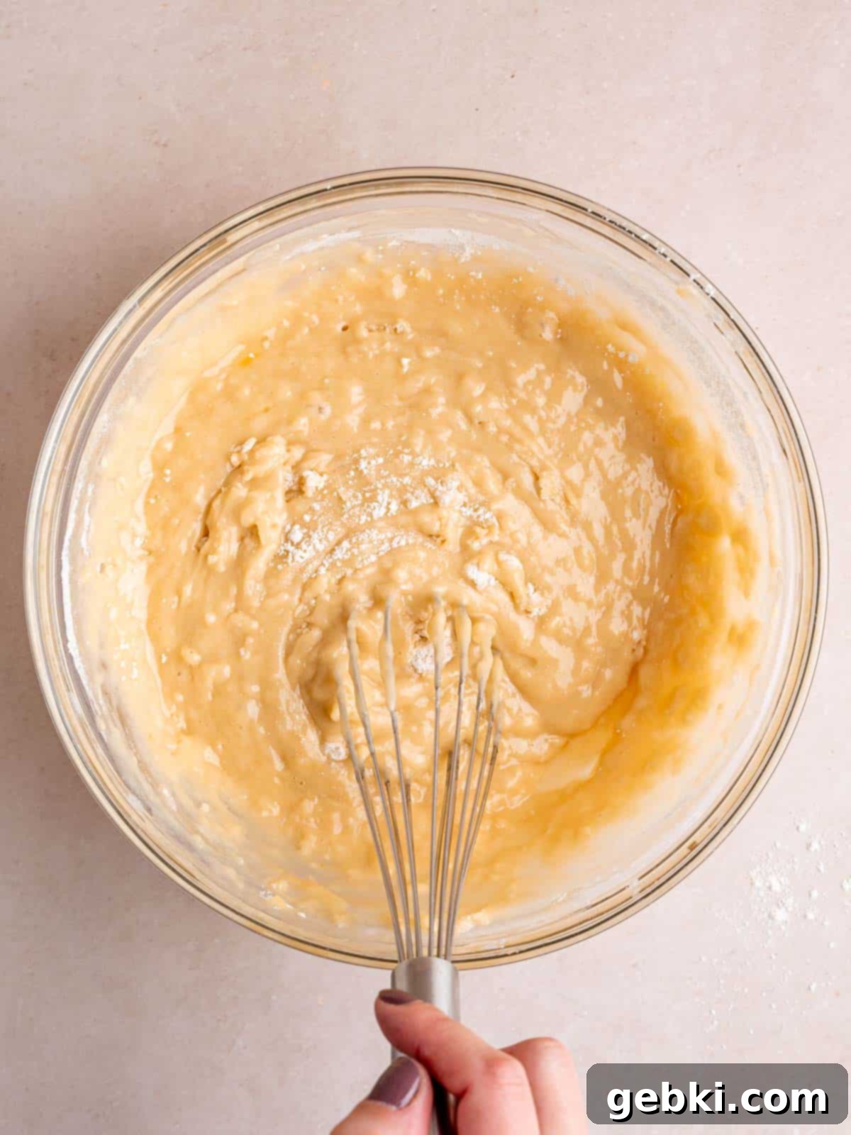 Quick and Easy Strawberry Muffins 7 Whisking dry muffin ingredients into the wet ingredients.