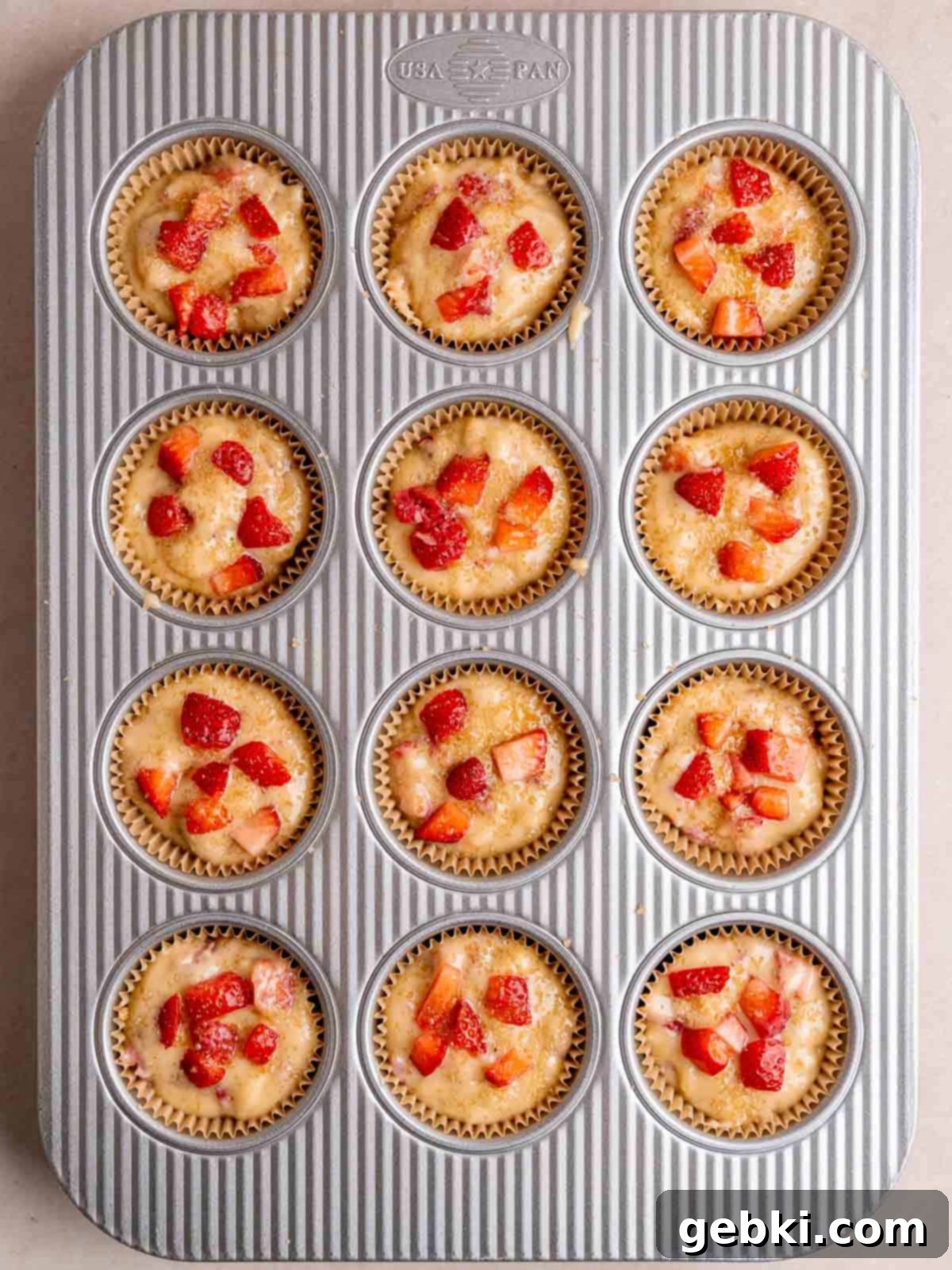 Quick and Easy Strawberry Muffins 9 A muffin pan filled with strawberry muffin batter.