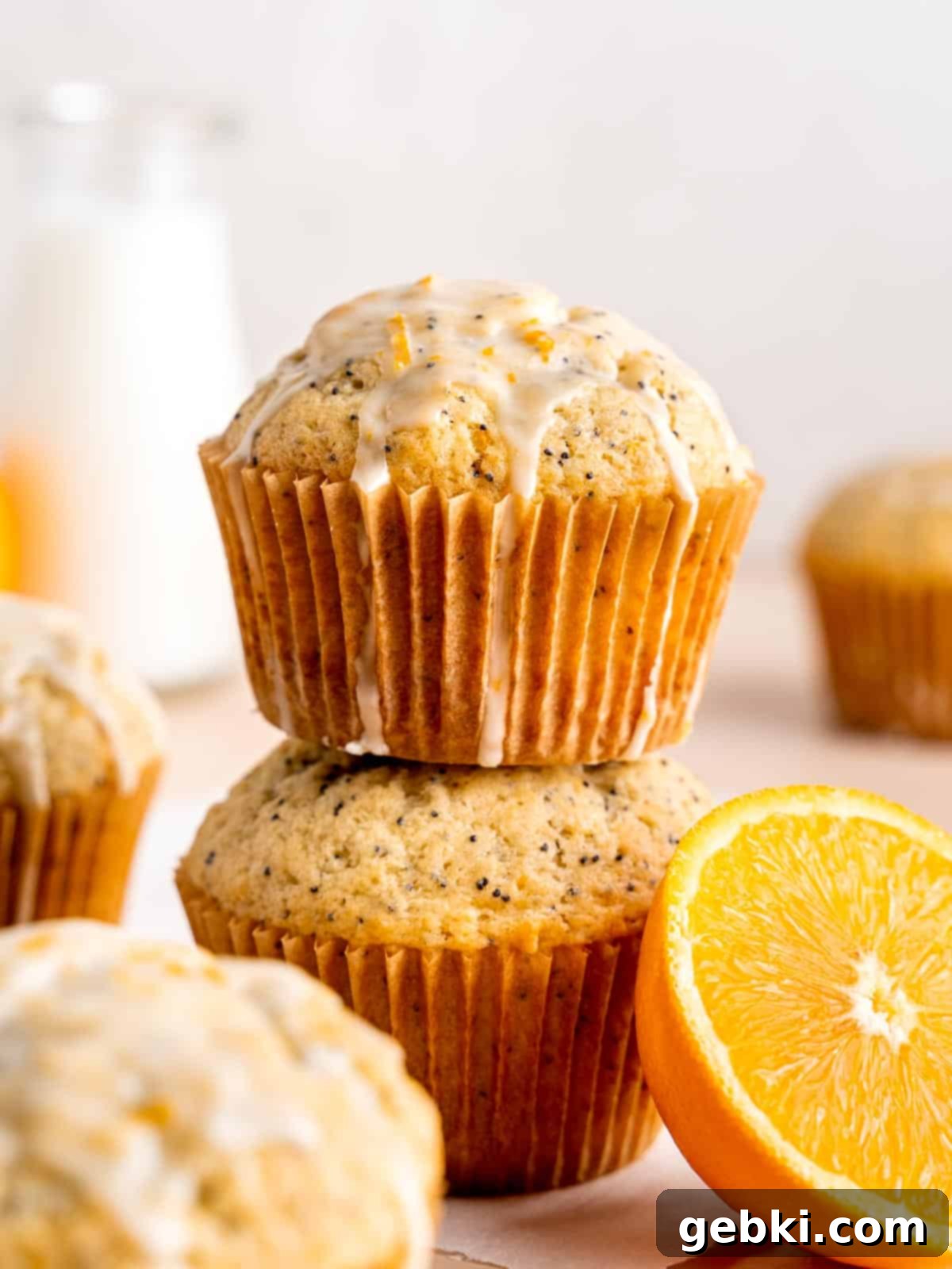 The Ultimate Guide To Homemade Muffin Liners 12 A stack of orange poppy seed muffins.