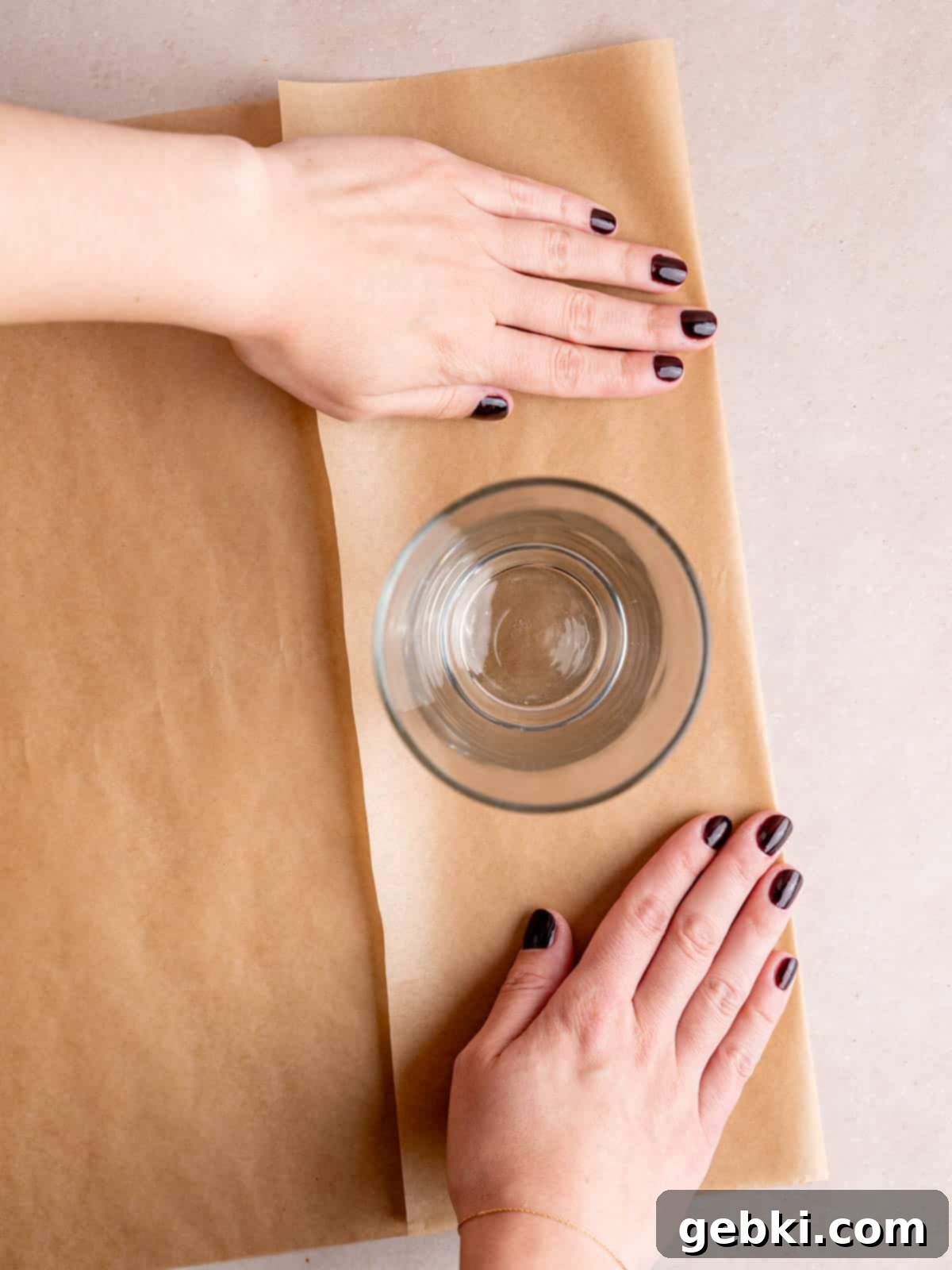 The Ultimate Guide To Homemade Muffin Liners 4 A pint glass sitting on top of a folded piece of parchment paper.