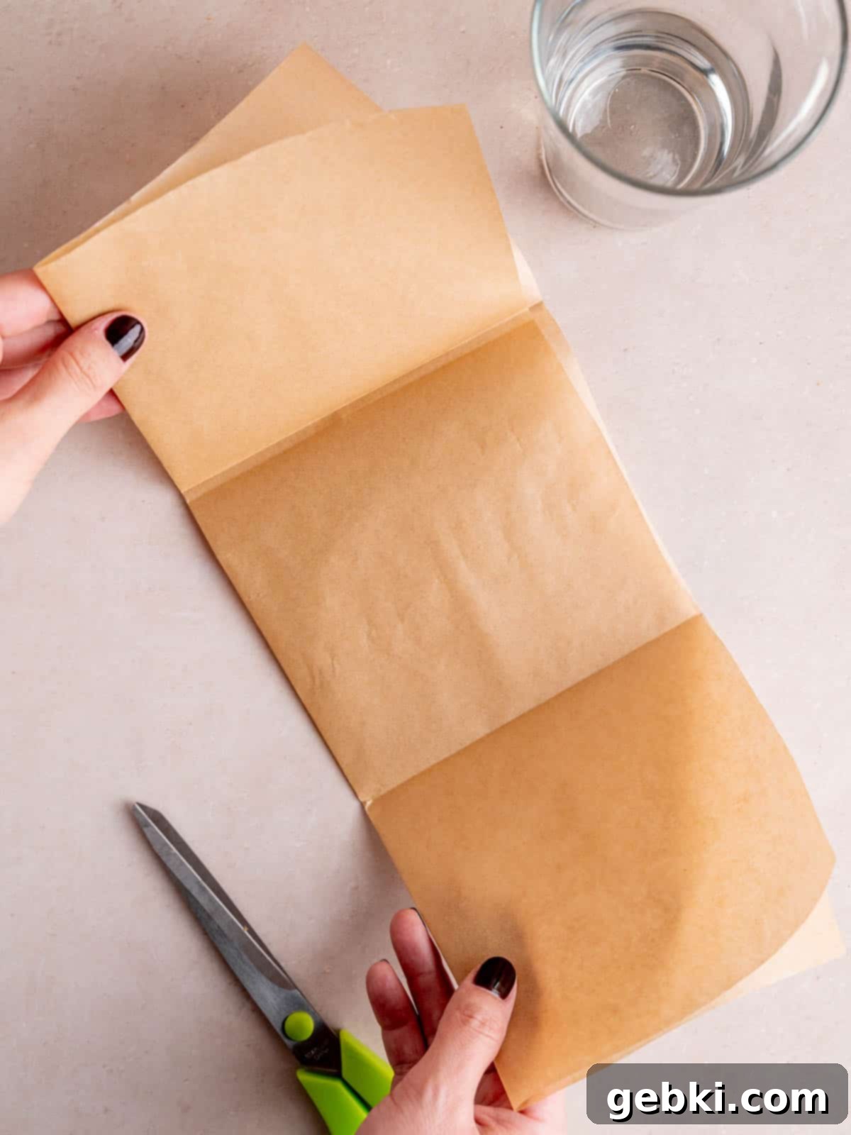 The Ultimate Guide To Homemade Muffin Liners 6 Folding parchment paper into thirds like a brochure.