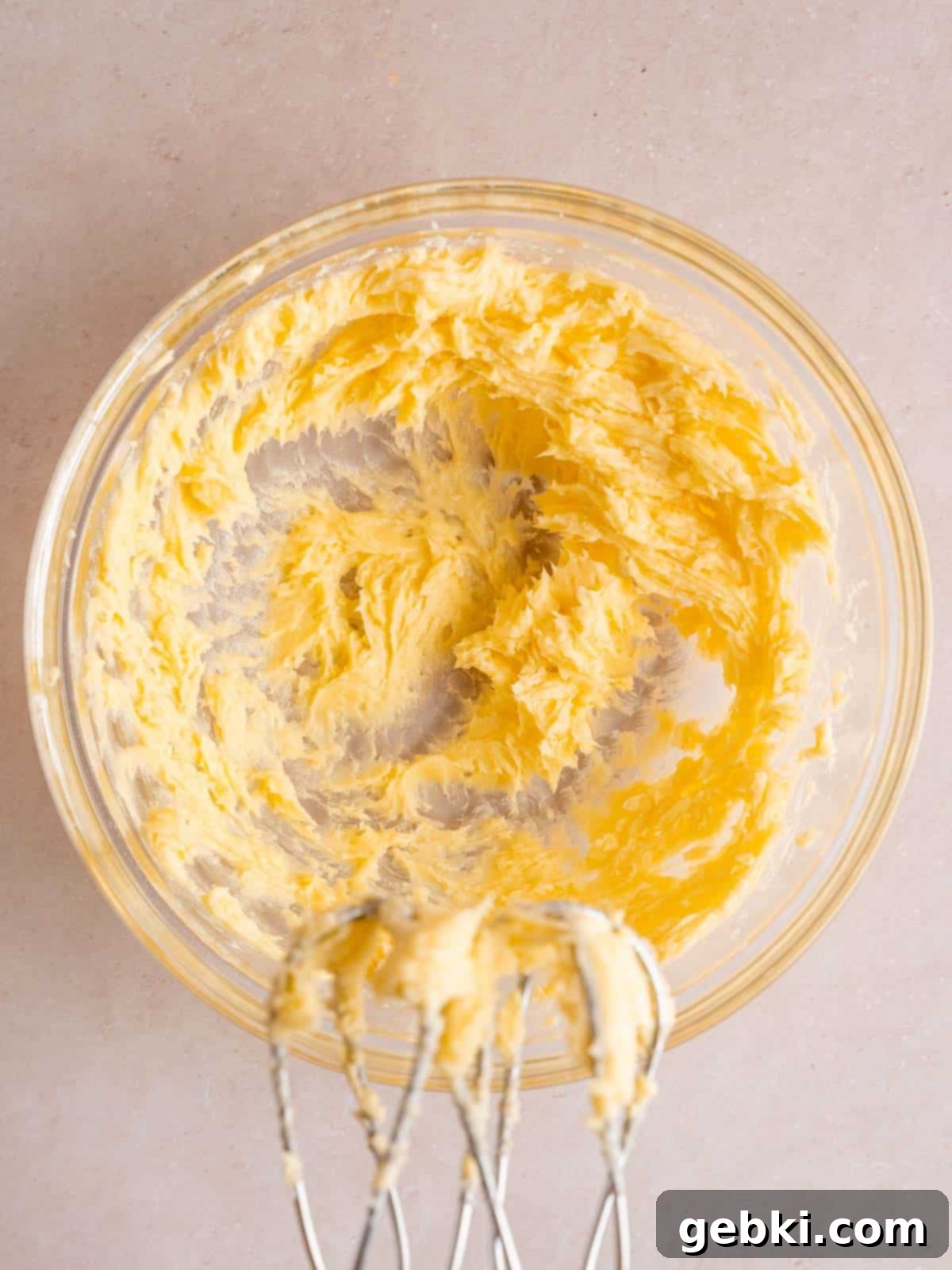 Wet ingredients for shortbread cookies, including butter, granulated sugar, powdered sugar, and extracts, beautifully creamed together in a bowl.