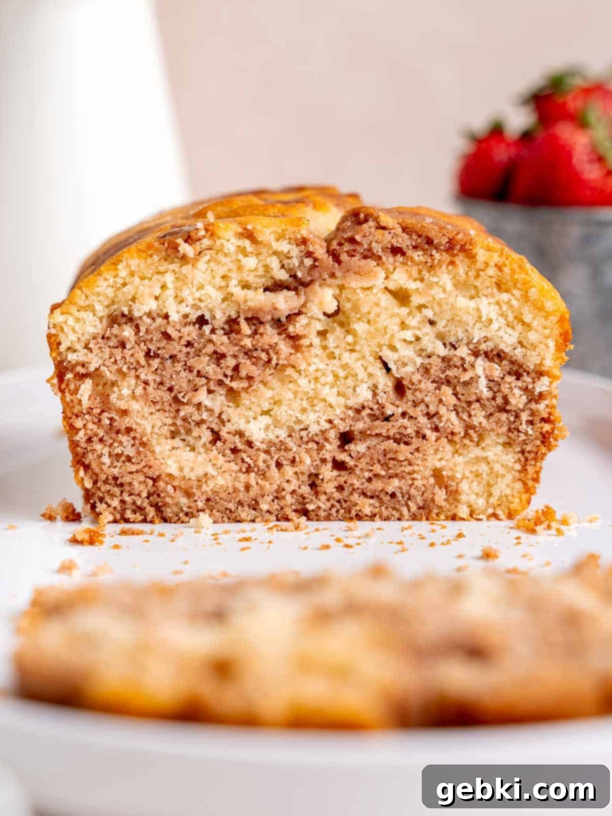 A loaf cake with vanilla and strawberry swirls.