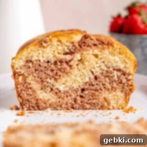 A loaf cake with vanilla and strawberry swirls.