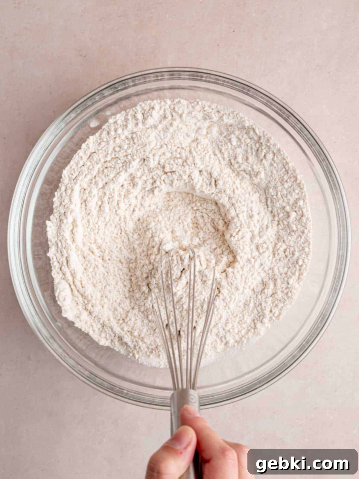 Whisking flour, baking powder, salt, and sugar in a bowl.
