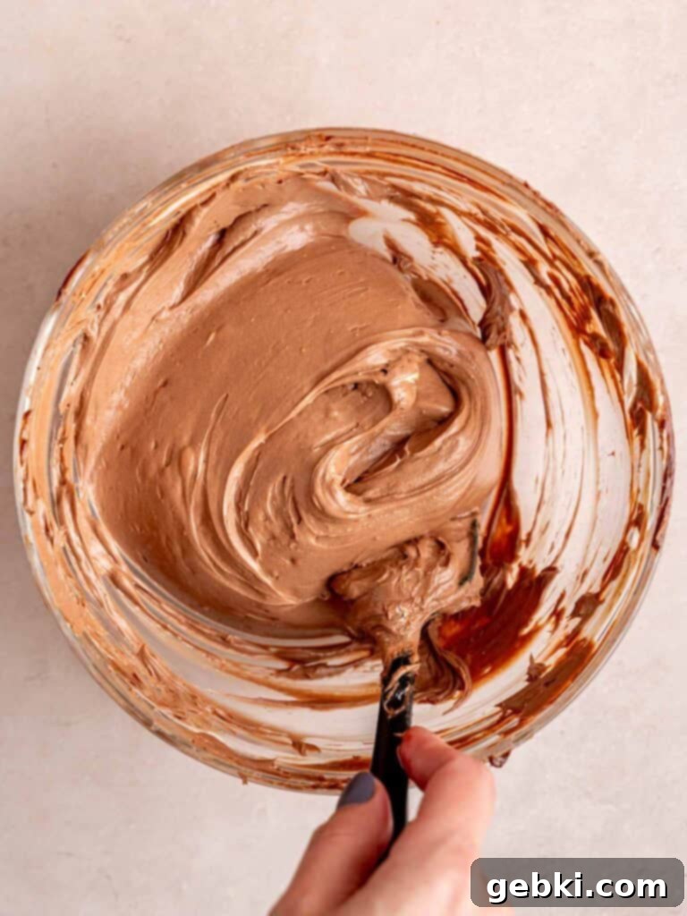 Creamy no bake chocolate cheesecake batter in a bowl.