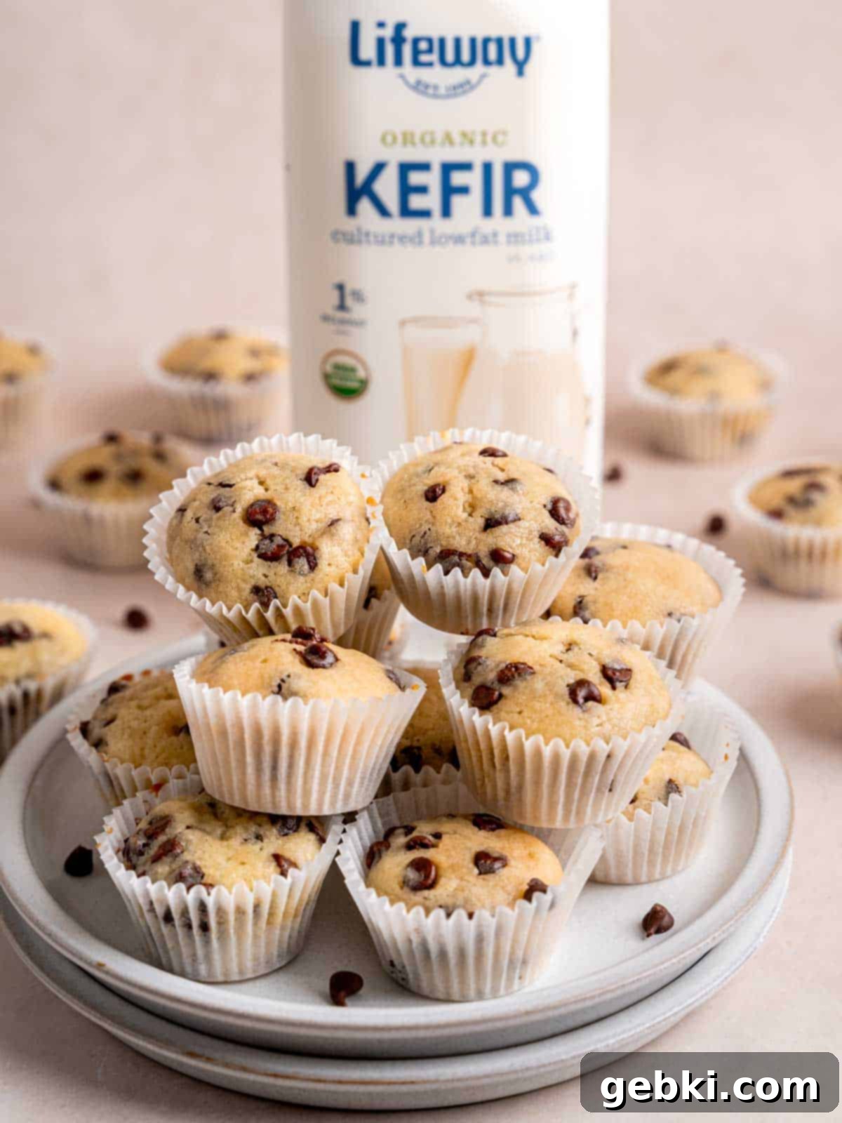 Mini chocolate chip muffins on a plate next to a bottle of Lifeway kefir.