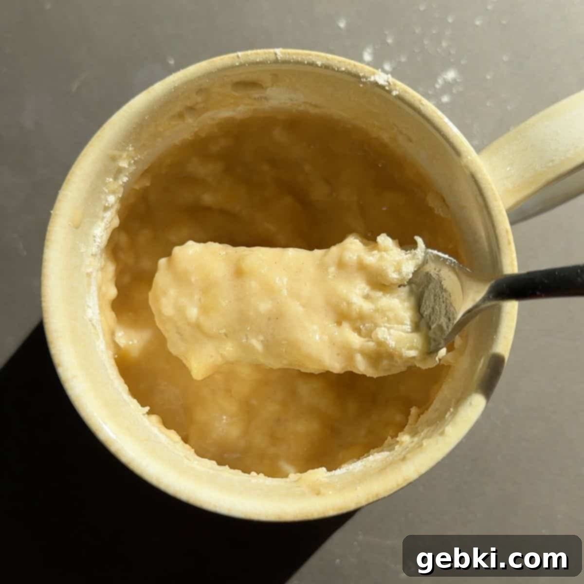 Speedy Eggless Banana Bread Mug Cake 8 Banana bread batter in a coffee mug after mixing in the flour with a fork, showing no dry streaks.