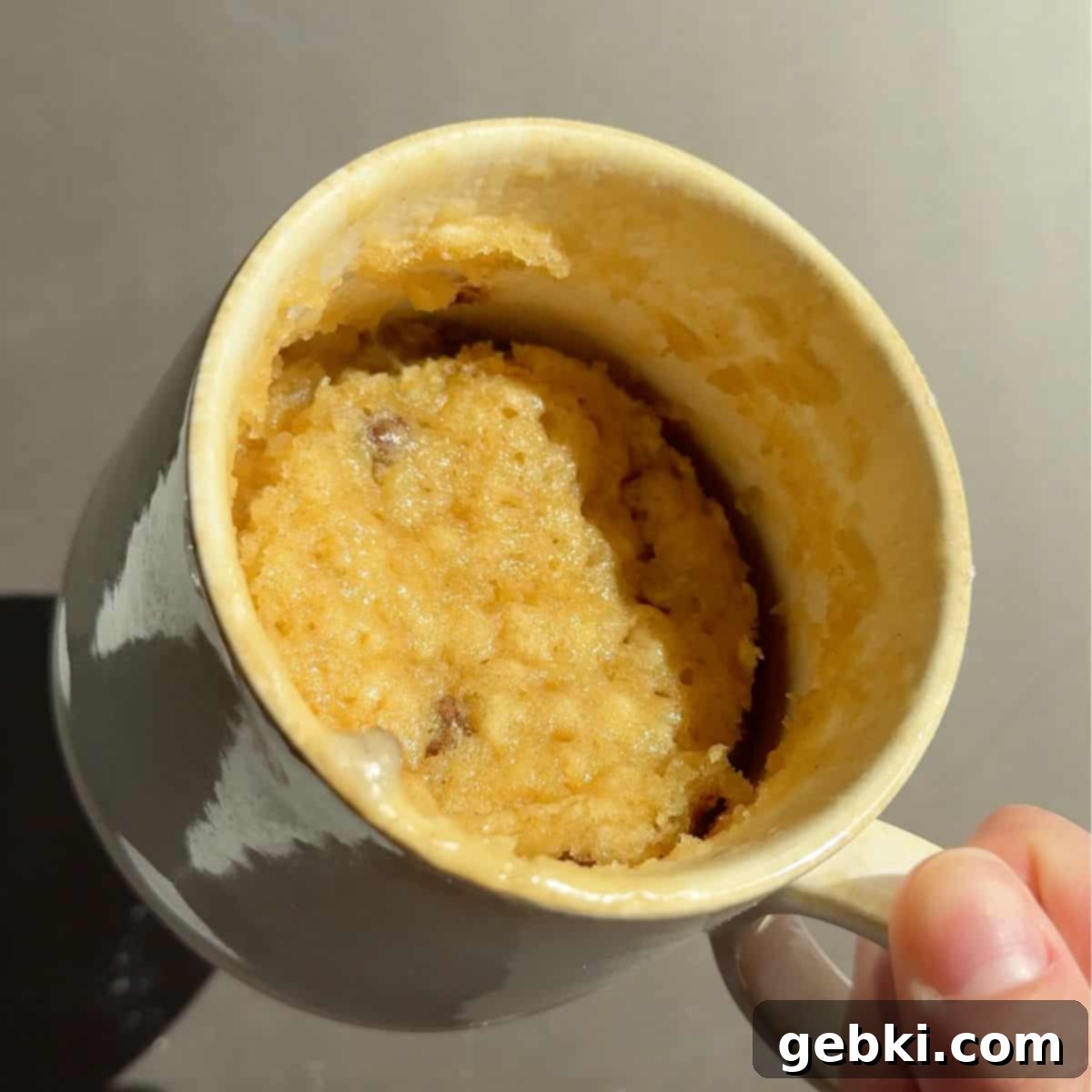 Speedy Eggless Banana Bread Mug Cake 9 A freshly microwaved chocolate chip banana bread mug cake, slightly risen and golden brown.
