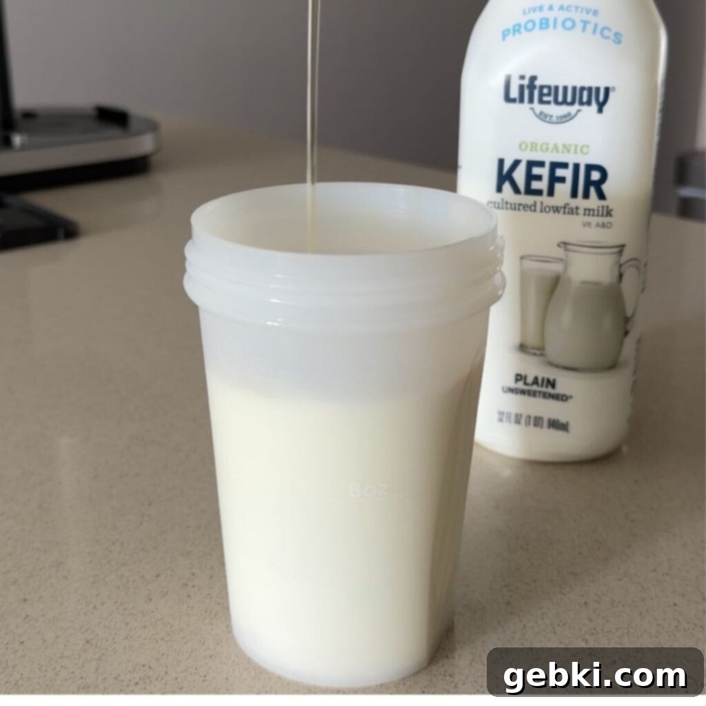 Simple Ninja Creami Cookies and Cream Kefir Ice Cream 4 Pouring honey into a cup of kefir, milk, and vanilla extract.