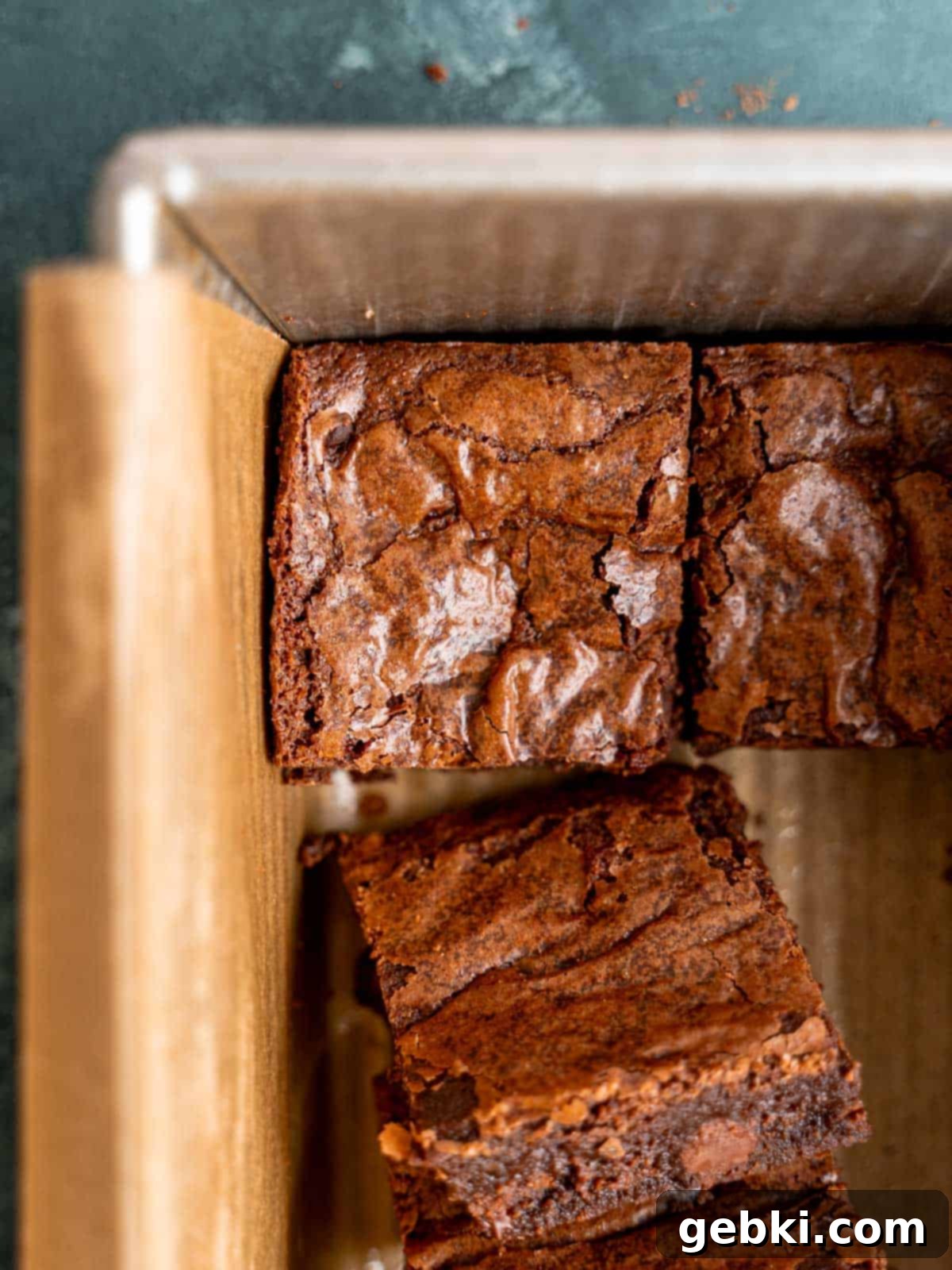A crinkle-top brownie in a parchment-lined loaf pan.